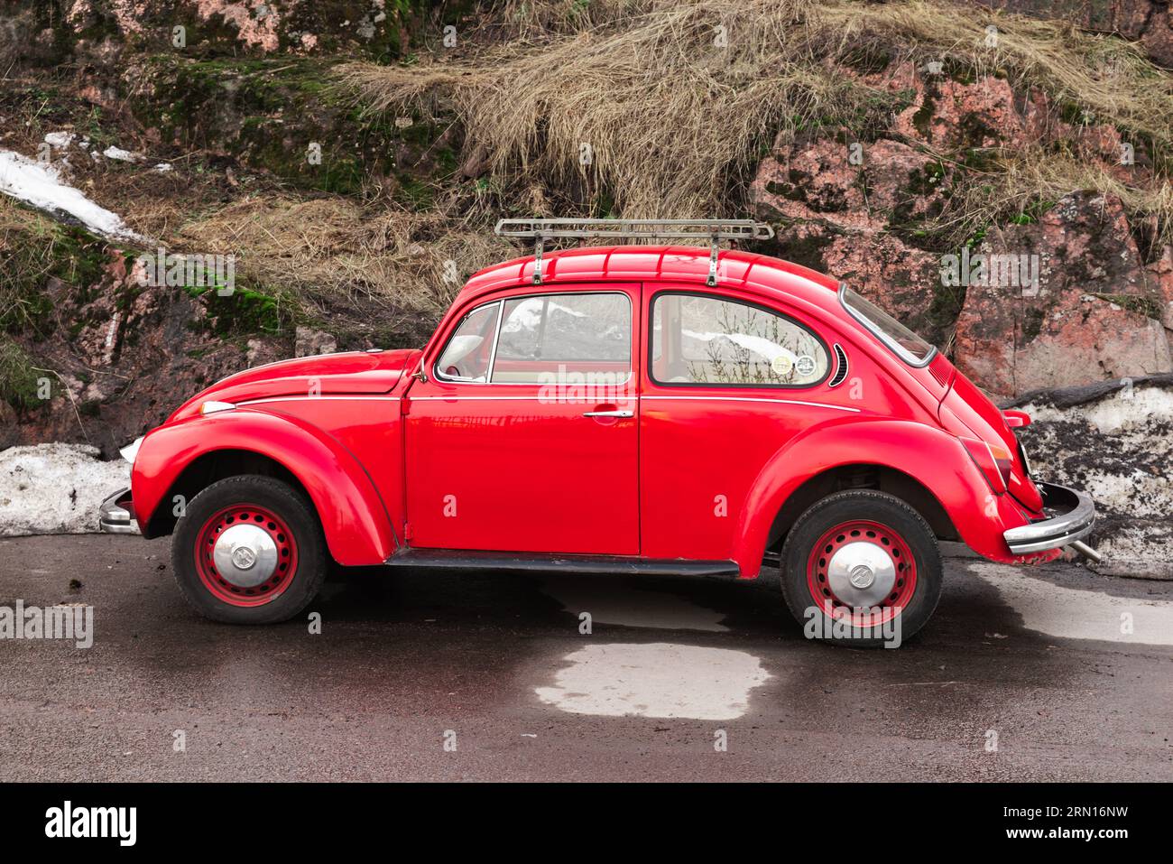 Vyborg, Russia - April 15, 2023: Vintage red Volkswagen Kafer stands on a roadside, side view Stock Photo