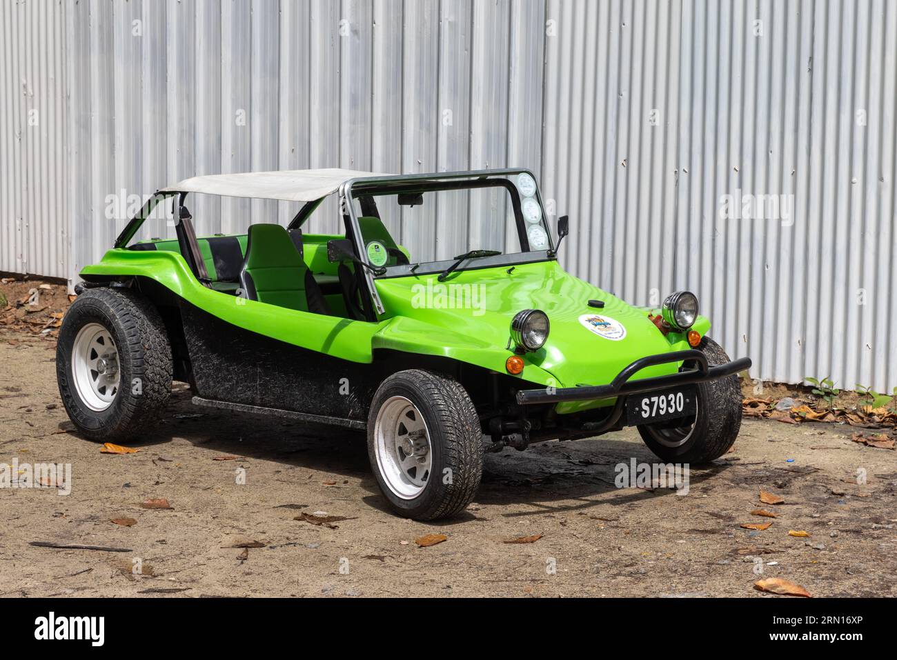 Mahe, Seychelles - August 7, 2023: Green black beach buggy stands parked on a sunny day Stock Photo