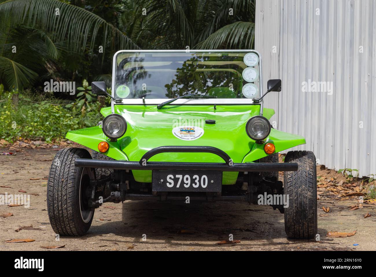Mahe, Seychelles - August 7, 2023: Front view of a green black beach buggy standing parked on a sunny day Stock Photo