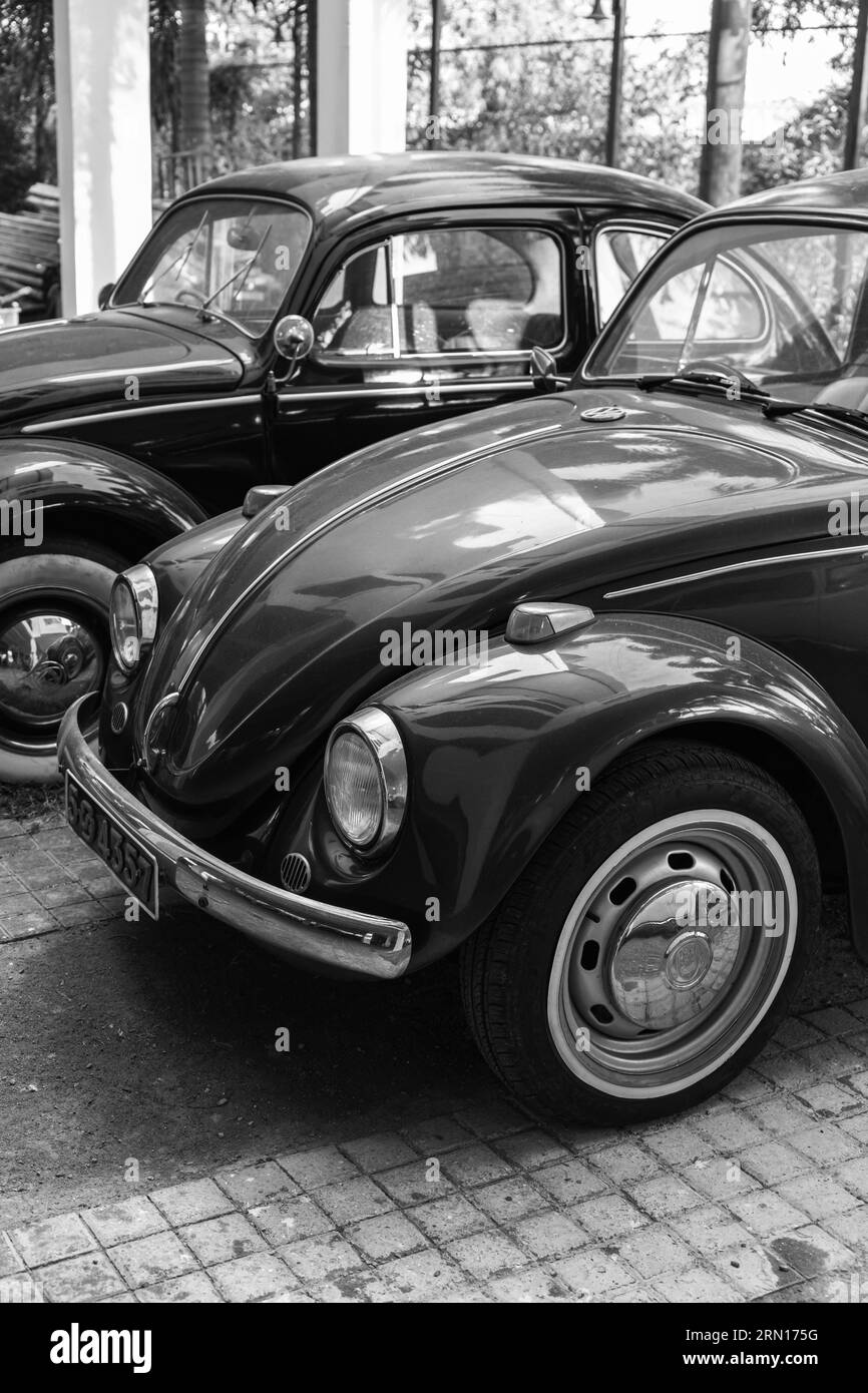 Colombo, Sri Lanka - November 30, 2021: Vintage Volkswagen Kafer cars stand parked on the street. Vertical black and white photo Stock Photo