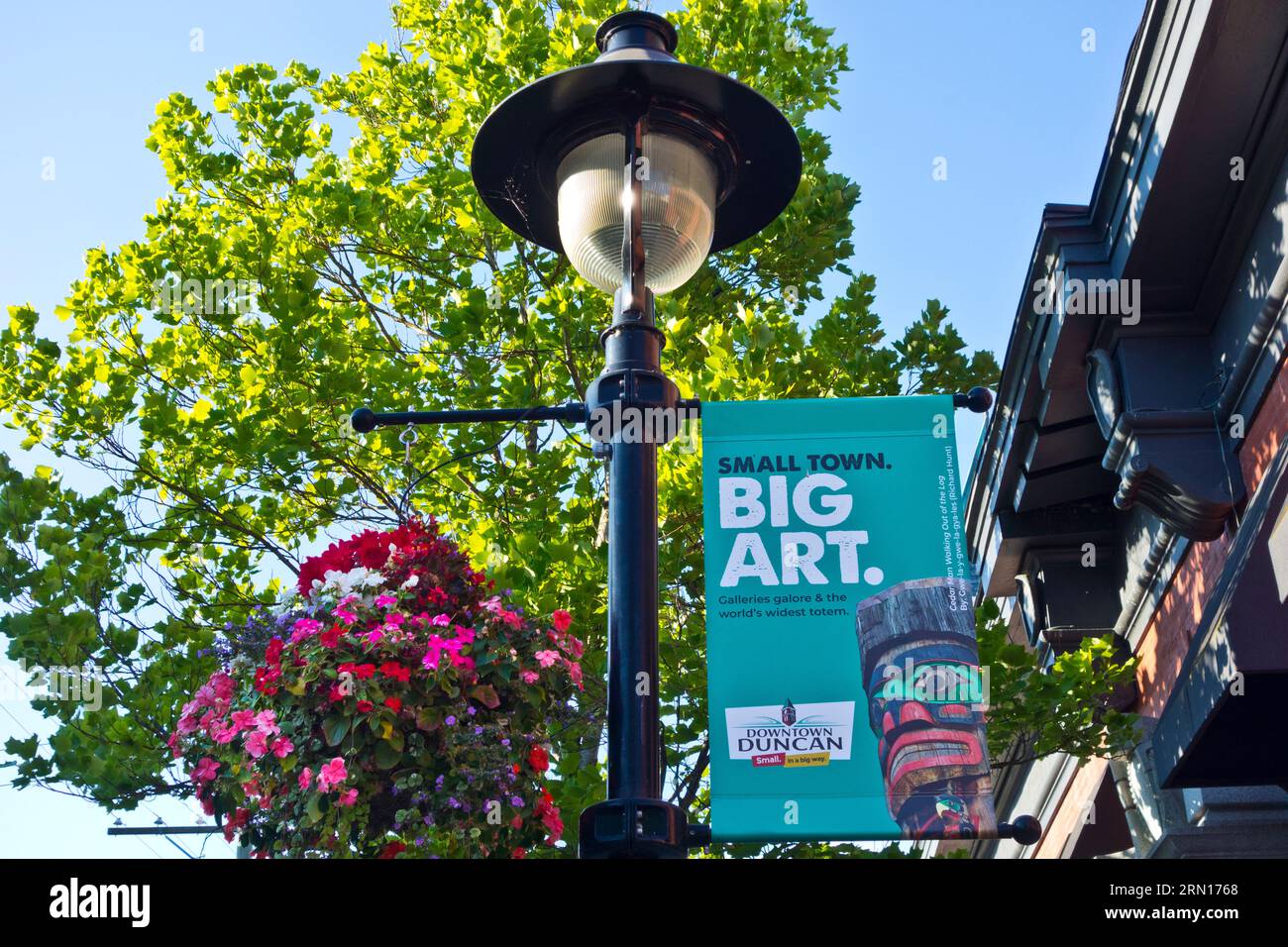 Colourful street banners and baskets of hanging flowers in downtown Duncan, British Columbia, Canada. Stock Photo