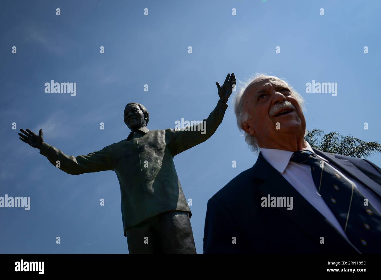 141205 -- PRETORIA, Dec.5, 2014 -- The laywer George Bizos, who helped the Nelson Mandela out of prison, stands before the Mandela statue in the Union Buildings, Pretoria, South Africa, on Dec.5, 2014. A wreath laying ceremony was held here Friday to mark the 1st anniversary of late South Africa s President Nelson Mandela s passing. South Africa s veterans of the struggle for freedom and those who fought with Nelson Mandela against apartheid were invited to lead the wreath laying.  SOUTH AFRICA-PRETORIA-MANDELA-1ST ANNIVERSARY-COMMEMORATION ZhaixJianlan PUBLICATIONxNOTxINxCHN Stock Photo