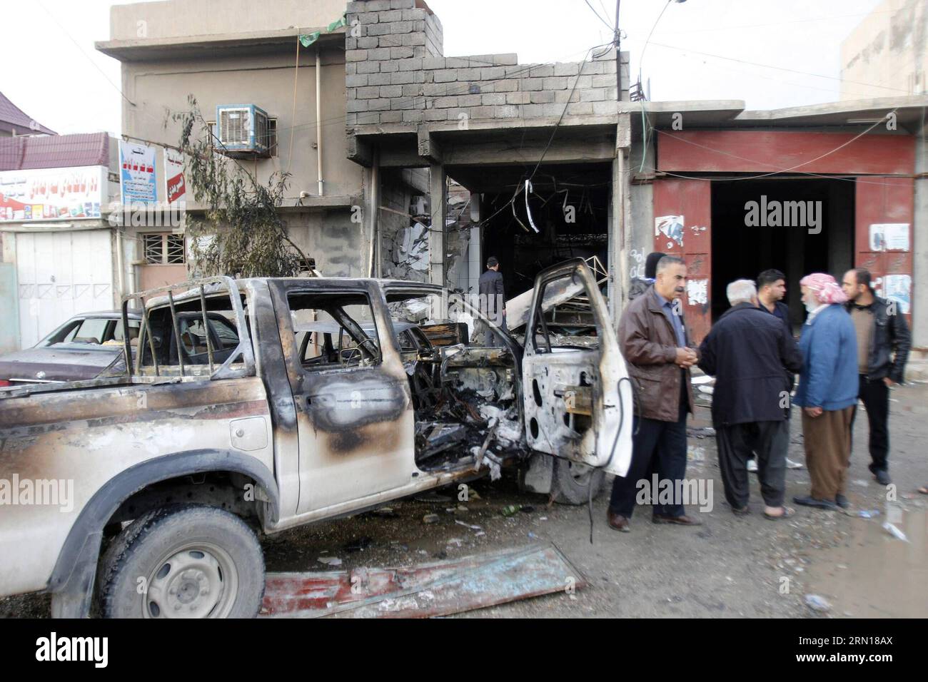 (141205) -- KIRKUK, Dec. 5, 2014 -- A damaged car is seen at an explosion site in the city of Kirkuk, Iraq, Dec 5, 2014. A suicide bomber with an explosive vest blew himself up in a cafe in the northern Iraqi city of Kirkuk, killing at least 15 people and wounding 20 others on Dec. 4, a local police told Xinhua on condition of anonymity. )(bxq) IRAQ-KIRKUK-SUICIDE BOMB DenaxAssad PUBLICATIONxNOTxINxCHN   Kirkuk DEC 5 2014 a damaged Car IS Lakes AT to Explosion Site in The City of Kirkuk Iraq DEC 5 2014 a Suicide Bombers With to Explosive Vest blew himself up in a Cafe in The Northern Iraqi Cit Stock Photo