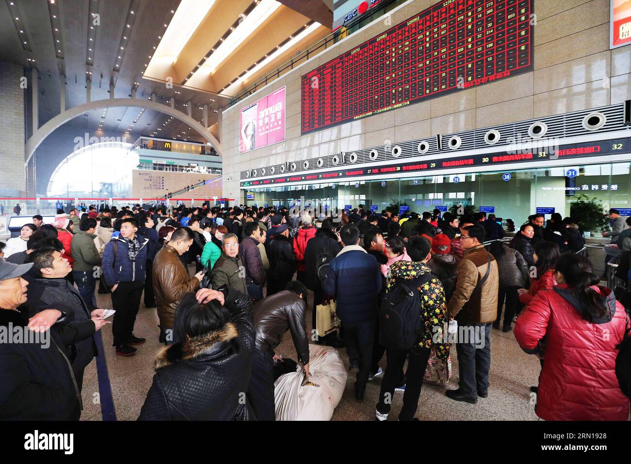 Passengers cram the ticket office of Shijiazhuang Railway Station in Shijiazhuang, capital of north China s Hebei Province, Dec. 7, 2014. China Railway Corporation (CRC), operator of China s rail network, started to sell train tickets for the 40-day travel period known as chunyun on Sunday . Chunyun , sometimes called the world s largest human migration, is the hectic travel period surrounding Chinese New Year. This year, chunyun will begin on Feb. 4 and last until March 16. ) (hdt) CHINA-RAILWAY-TICKET (CN) ZhengxRongxi PUBLICATIONxNOTxINxCHN   Passengers CRAM The Ticket Office of Shijiazhuan Stock Photo
