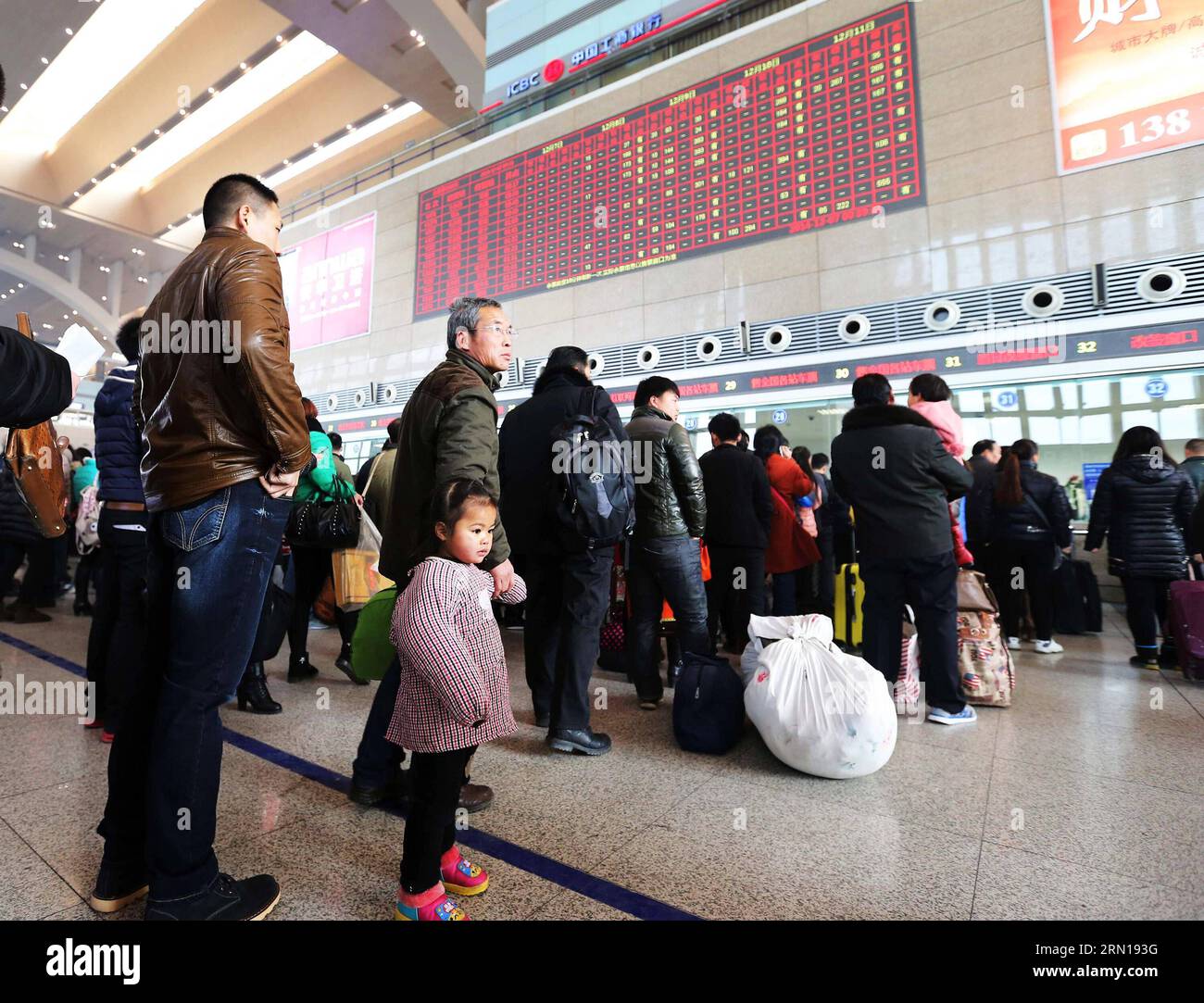 Passengers buy tickets at Shijiazhuang Railway Station in Shijiazhuang, capital of north China s Hebei Province, Dec. 7, 2014. China Railway Corporation (CRC), operator of China s rail network, started to sell train tickets for the 40-day travel period known as chunyun on Sunday . Chunyun , sometimes called the world s largest human migration, is the hectic travel period surrounding Chinese New Year. This year, chunyun will begin on Feb. 4 and last until March 16. ) (hdt) CHINA-RAILWAY-TICKET (CN) ZhengxRongxi PUBLICATIONxNOTxINxCHN   Passengers Buy Tickets AT Shijiazhuang Railway Station in S Stock Photo