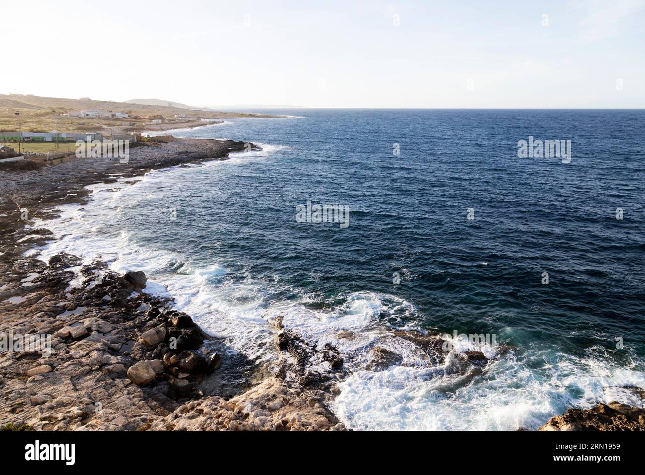 Morning at St Julian's in Malta. The Mediterranean Sea laps against the rocky coastline near Pembroke Atletha FC's soccer pitch. Stock Photo