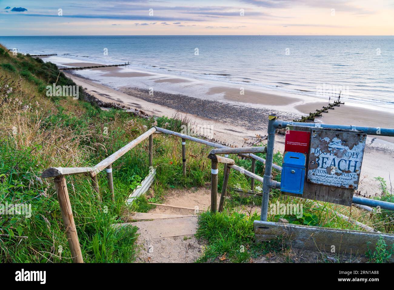 Steps down to the beach in Mundesley in North Norfolk, UK at sunrise Stock Photo