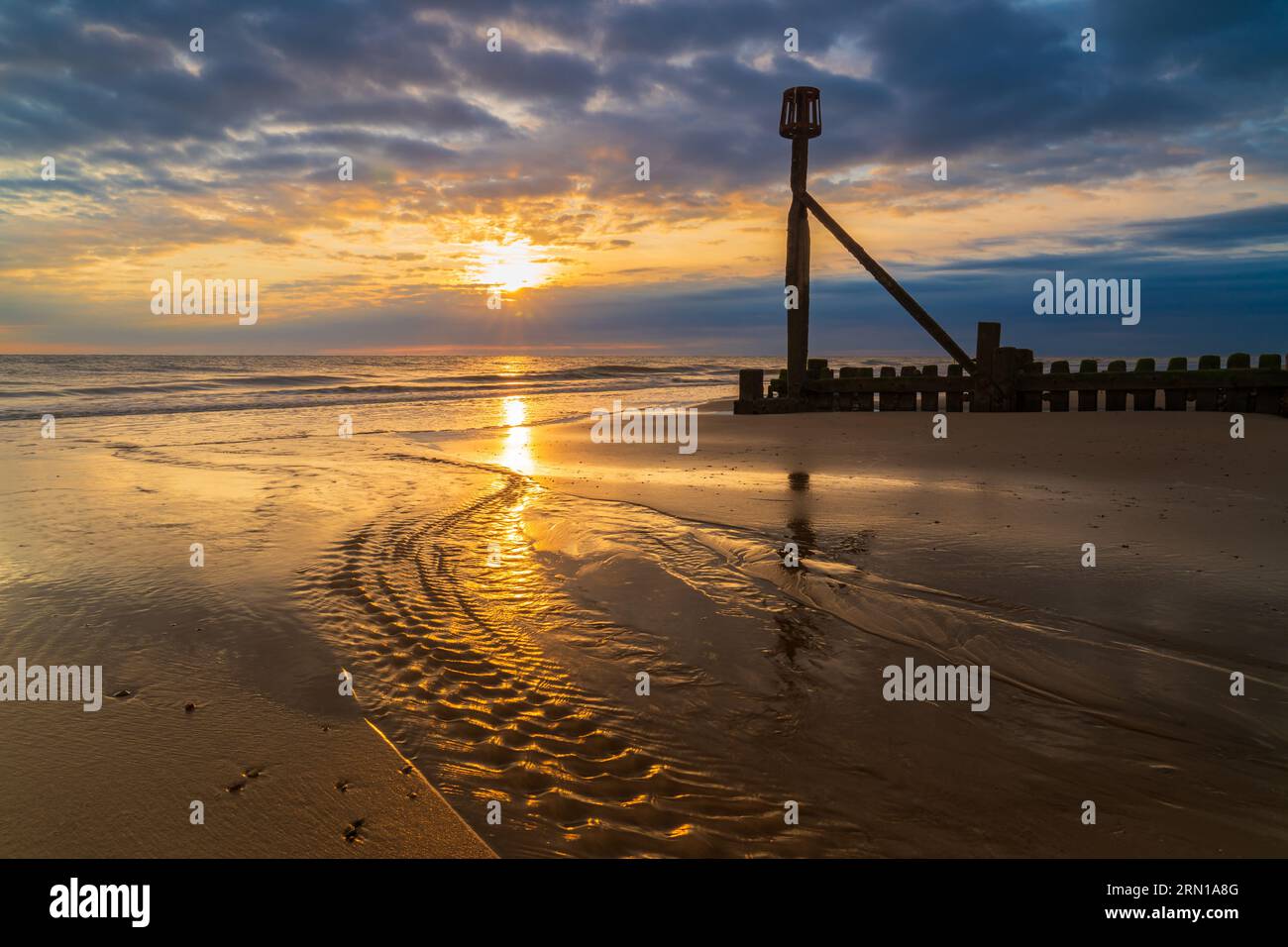 A landscape image of the sunrise on the beach in Mundesley, North Norfolk, UK Stock Photo