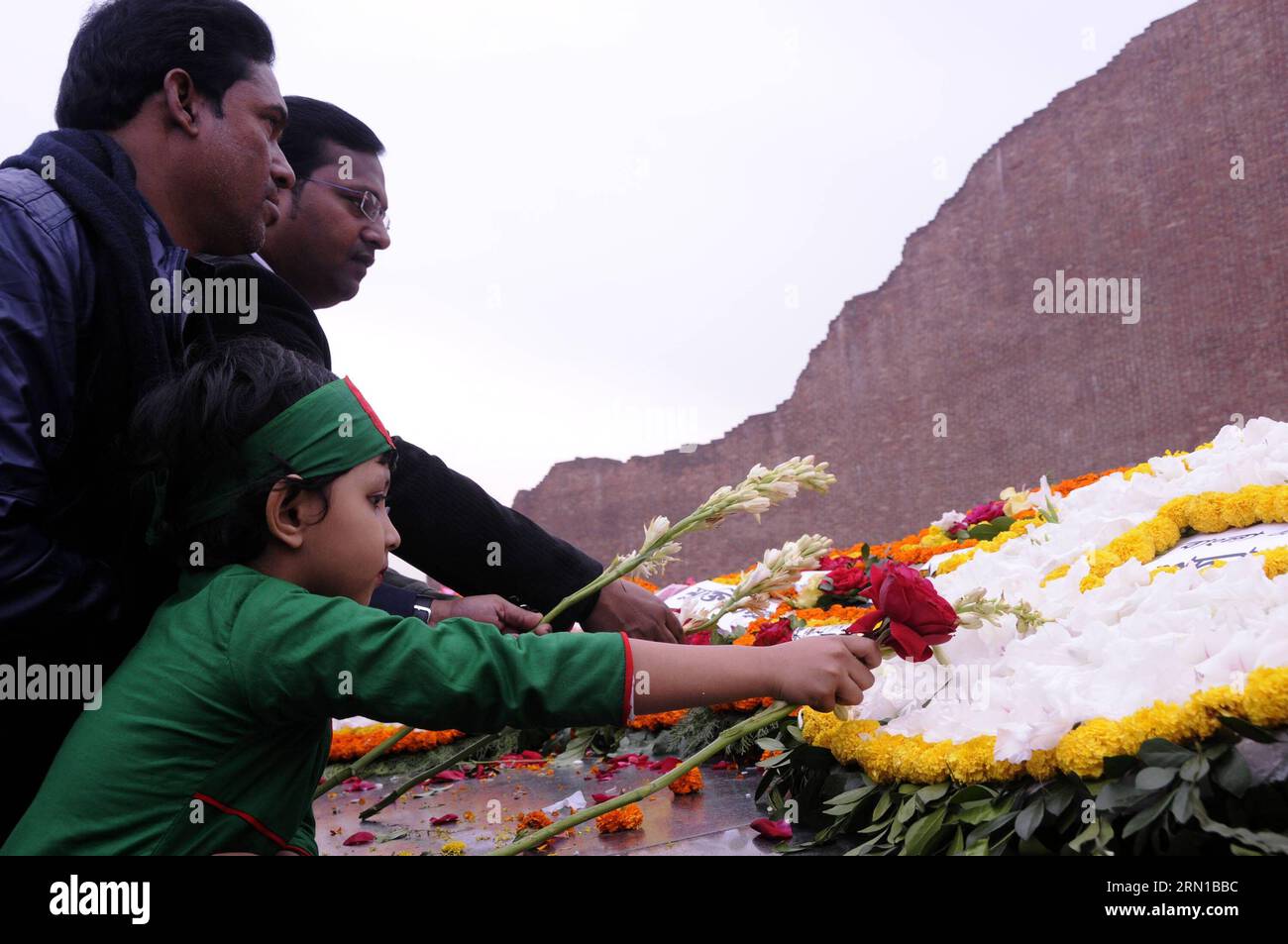 (141214) -- DHAKA, Dec. 14, 2014 -- Bangladeshi people pay tribute with flowers in front of the Martyred Intellectual Memorial on Martyred Intellectuals Day at Rayerbazar in Dhaka, Bangladesh, Dec. 14, 2014. Bangladesh observed Martyred Intellectuals Day in commemoration of the martyrdom of the members of the intelligentsia who were assassinated at fag end of Bangladesh liberation war. The victims of this genocide were mostly eminent academicians, litterateurs, doctors, engineers, journalists and other notable personalities. ) (lyi) BANGLADESH-DHAKA-MARTYRED INTELLECTUALS DAY SharifulxIslam PU Stock Photo