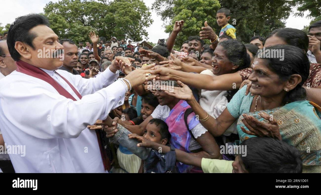 (141218) -- COLOMBO, Dec. 18, 2014 -- Sri Lankan President Mahinda Rajapaksa (L) greets his supporters during an election rally in Mullaitivu, northern Sri Lanka, on Dec. 18, 2014. Sri Lankan President Mahinda Rajapaksa on Thursday held election rallies in former rebel held northern areas and sought the support of minority Tamils for his bid for a third term in office. ) SRI LANKA-MULLAITIVU-MAHINDA RAJAPAKSA-ELECTION RALLY EaswaranxRutnam PUBLICATIONxNOTxINxCHN   Colombo DEC 18 2014 Sri Lankan President Mahinda Rajapaksa l greets His Supporters during to ELECTION Rally in  Northern Sri Lanka Stock Photo