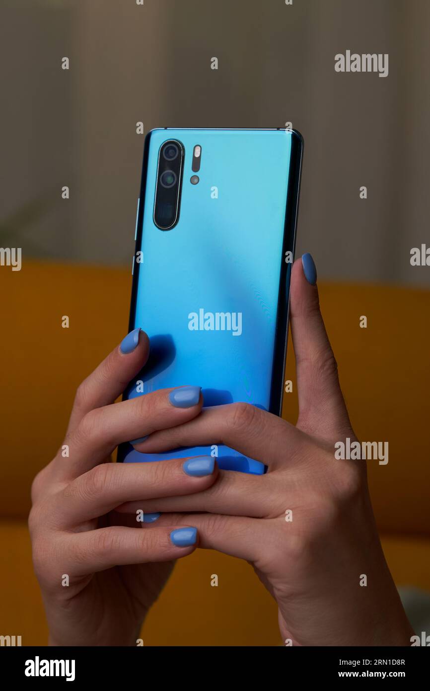 Womans hands is using smartphone, writing a message, browsing social networks. Technologies for life and work. Stock Photo