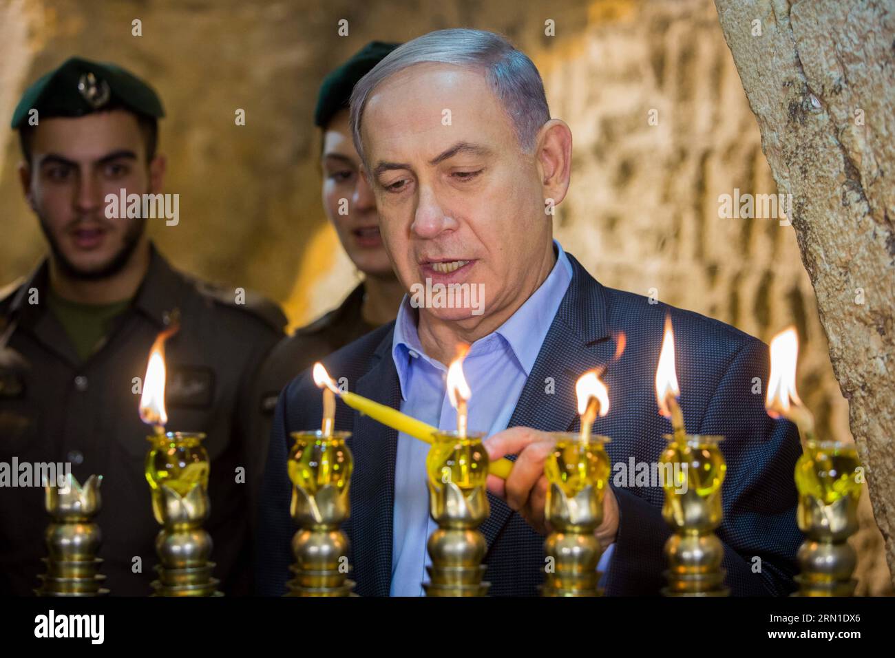 Israeli Prime Minister Benjamin Netanyahu (1st R) attends a ceremony to mark the fifth night of Hanukkah at the Western Wall in the Old City of Jerusalem, on Dec. 20, 2014. Hanukkah, also known as the Festival of Lights and Feast of Dedication, is an eight-day Jewish holiday commemorating the rededication of the Holy Temple (the Second Temple) in Jerusalem at the time of the Maccabean Revolt against the Seleucid Empire of the 2nd Century B.C. Hanukkah is observed for eight nights and days, starting on the 25th day of Kislev according to the Hebrew calendar, which may occur at any time from lat Stock Photo