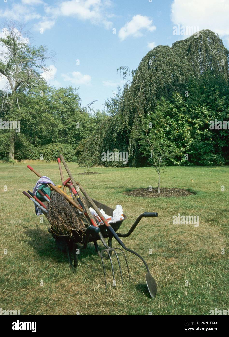 wheelbarrow carrying gardening tools in Kew Gardens, Surrey, London