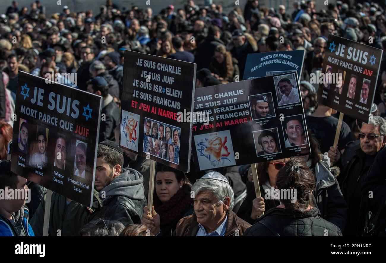 (150113) -- JERUSALEM, Jan. 13, 2015 -- People hold placards during a funeral ceremony for the four victims of Paris supermarket attack at Givat Shaul cemetery, on the outskirts of Jerusalem, on Jan. 13, 2015. Israeli leaders and multitude of mourners gathered Tuesday with the families of four Jewish victims of last week s terror attack on a Paris kosher supermarket for a solemn funeral ceremony at a Jerusalem cemetery. Yoav Hattab, Yohan Cohen, Philippe Braham and Francois-Michel Saada, were gunned down on Friday during a hostage attack on Hyper Casher supermarket in eastern Paris. They were Stock Photo