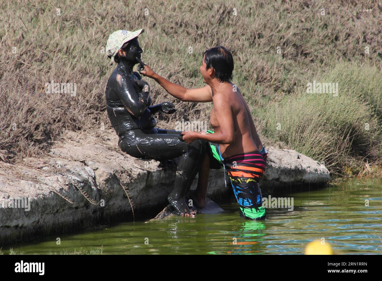 Woman smears mud on hi-res stock photography and images - Alamy