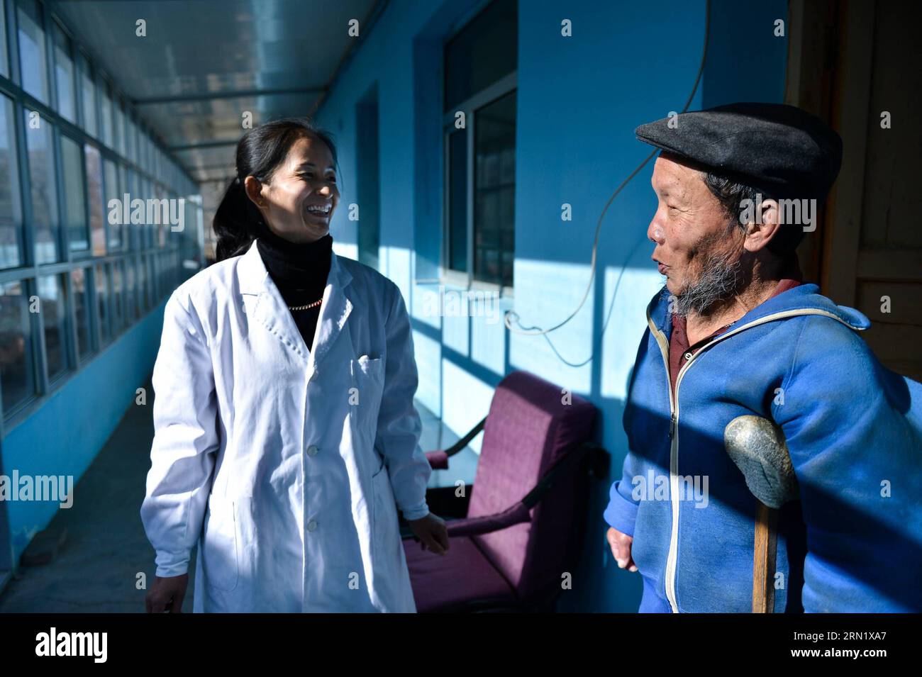 (150124) -- XINING, Jan. 21, 2015 -- Zhang Qingyun (L), a nurse at Tongren chronic disease control and prevention hospital, talks with patient Wen Changtai at the hospital in Tongren County, Huangnan Tibetan Autonomous Prefecture, northwest China s Qinghai Province, Jan. 21, 2015. The Tongren chronic disease control and prevention hospital is the only professional leprosary in Qinghai, where leprosy, also known as Hansen s disease, used to be prevalent before the founding of the country. Now the disease has been effectively controlled, and the incidence rate has decreased significantly. The 62 Stock Photo