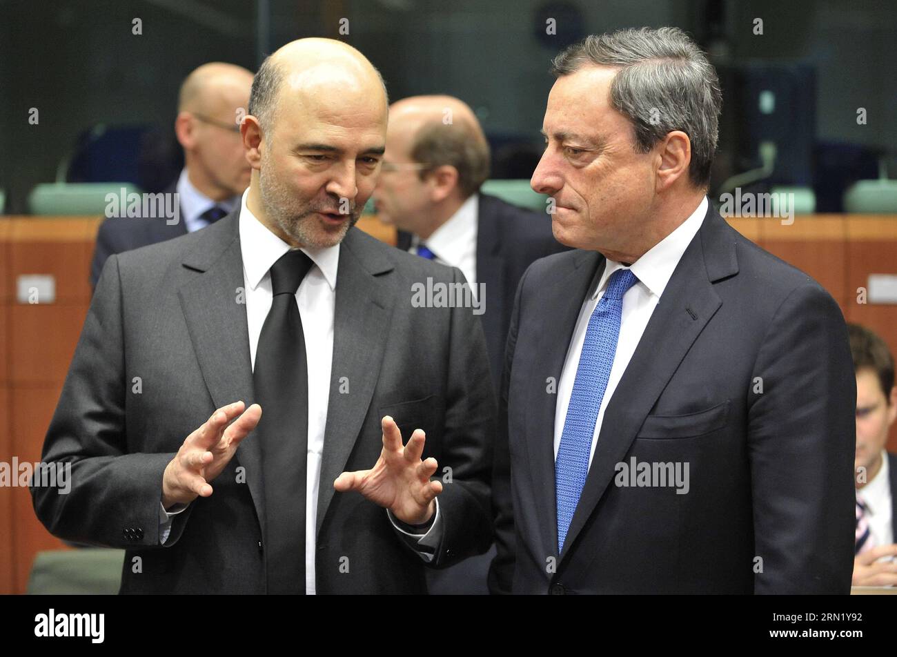 (150126) -- BRUSSELS, Jan. 26, 2015 -- European Commissioner for Economic and Financial Affairs, Taxation and Customs Pierre Moscovici (L) speaks with European Central Bank (ECB) President Mario Draghi prior to an Eurogroup finance ministers meeting at EU headquarters in Brussels, Belgium, Jan. 26, 2015. ) BELGIUM-BRUSSELS-EUROGROUP-MEETING YexPingfan PUBLICATIONxNOTxINxCHN   Brussels Jan 26 2015 European Commissioner for Economic and Financial Affairs Taxation and Customs Pierre Moscovici l Speaks With European Central Bank ECB President Mario Draghi Prior to to Euro Group Finance Minister Me Stock Photo