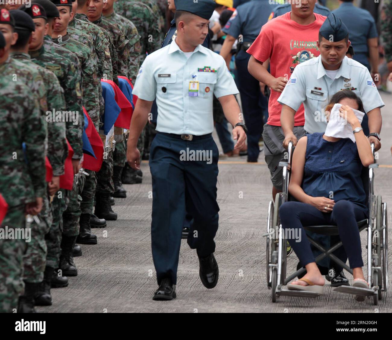 (150129) -- PASAY CITY, Jan. 29, 2015 -- A pregnant relative of one of the fallen Philippine National Police Special Action Force (PNP-SAF) members sits in a wheelchair after fainting at the Villamor Air Base in Pasay City, the Philippines, Jan. 29, 2015. Forty-four members of the PNP-SAF were killed allegedly by Moro Islamic Liberation Front and Bangsamoro Islamic Freedom Fighters members on Jan. 25 in Mamasapano, Maguindanao. ) PHILIPPINES-PASAY CITY-POLICE RouellexUmali PUBLICATIONxNOTxINxCHN   Pasay City Jan 29 2015 a Pregnant relative of One of The Fall Philippine National Police Special Stock Photo