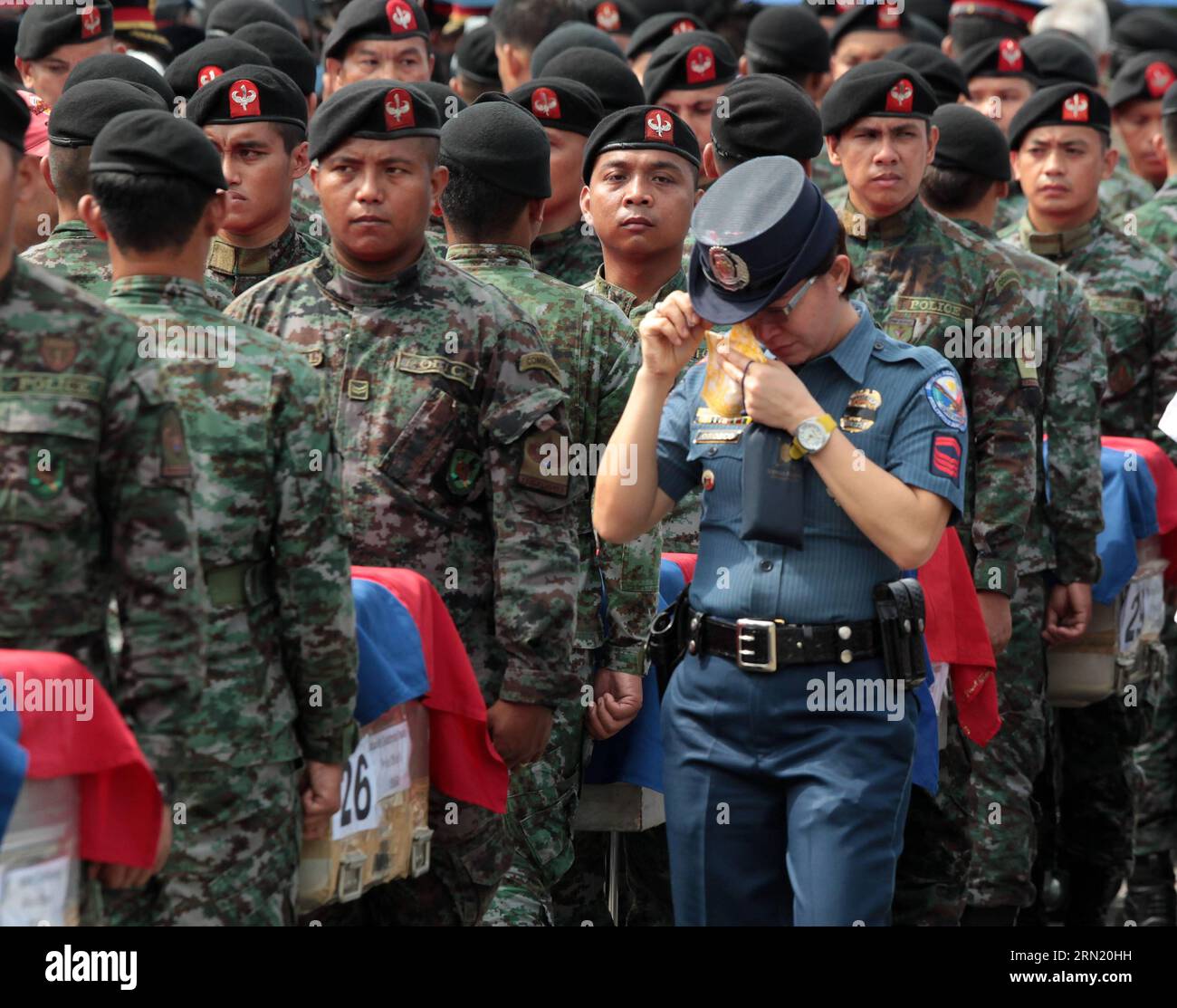 (150129) -- PASAY CITY, Jan. 29, 2015 -- A policewoman weeps as she walks past the caskets carrying the fallen members of the Philippine National Police Special Action Force (PNP-SAF) at the Villamor Air Base in Pasay City, the Philippines, Jan. 29, 2015. Forty-four members of the PNP-SAF were killed allegedly by Moro Islamic Liberation Front and Bangsamoro Islamic Freedom Fighters members on Jan. 25 in Mamasapano, Maguindanao. ) PHILIPPINES-PASAY CITY-POLICE RouellexUmali PUBLICATIONxNOTxINxCHN   Pasay City Jan 29 2015 a police woman  As She Walks Past The casket carrying The Fall Members of Stock Photo