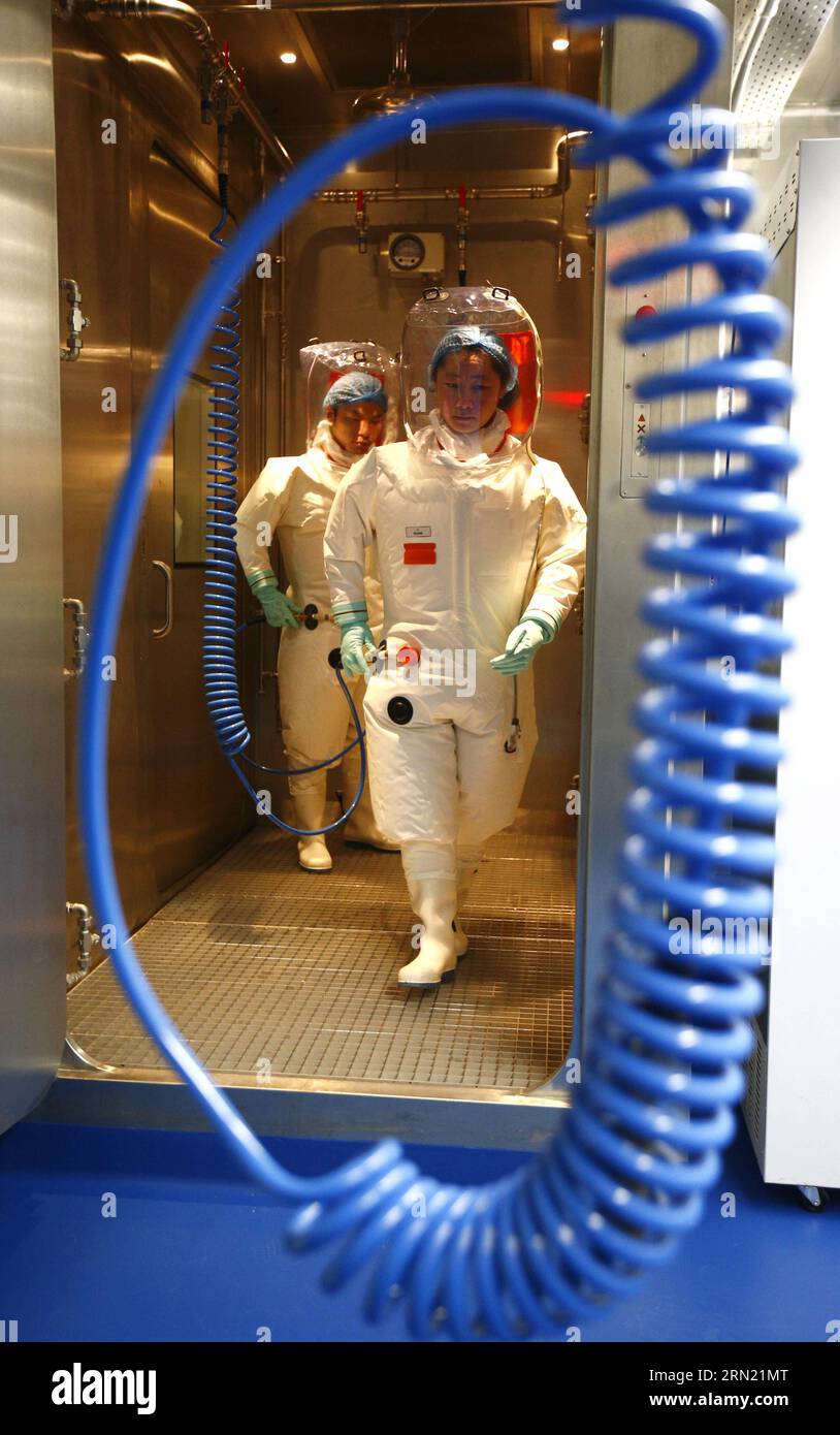 150131 -- WUHAN,   Researchers wearing protective suits enter the newly-completed lab in Wuhan, capital of central China s Hubei Province, Jan. 30, 2015. China completed its first high level biosafety laboratory based in Wuhan Saturday in Wuhan after more than a decade of construction. The lab will be used to study class four pathogens P4, which refers to the most virulent viruses that pose a high risk of aerosol-transmitted person-to-person infections.  wyo CHINA-WUHAN-BIOSAFETY LAB CN YinxGang PUBLICATIONxNOTxINxCHN Stock Photo