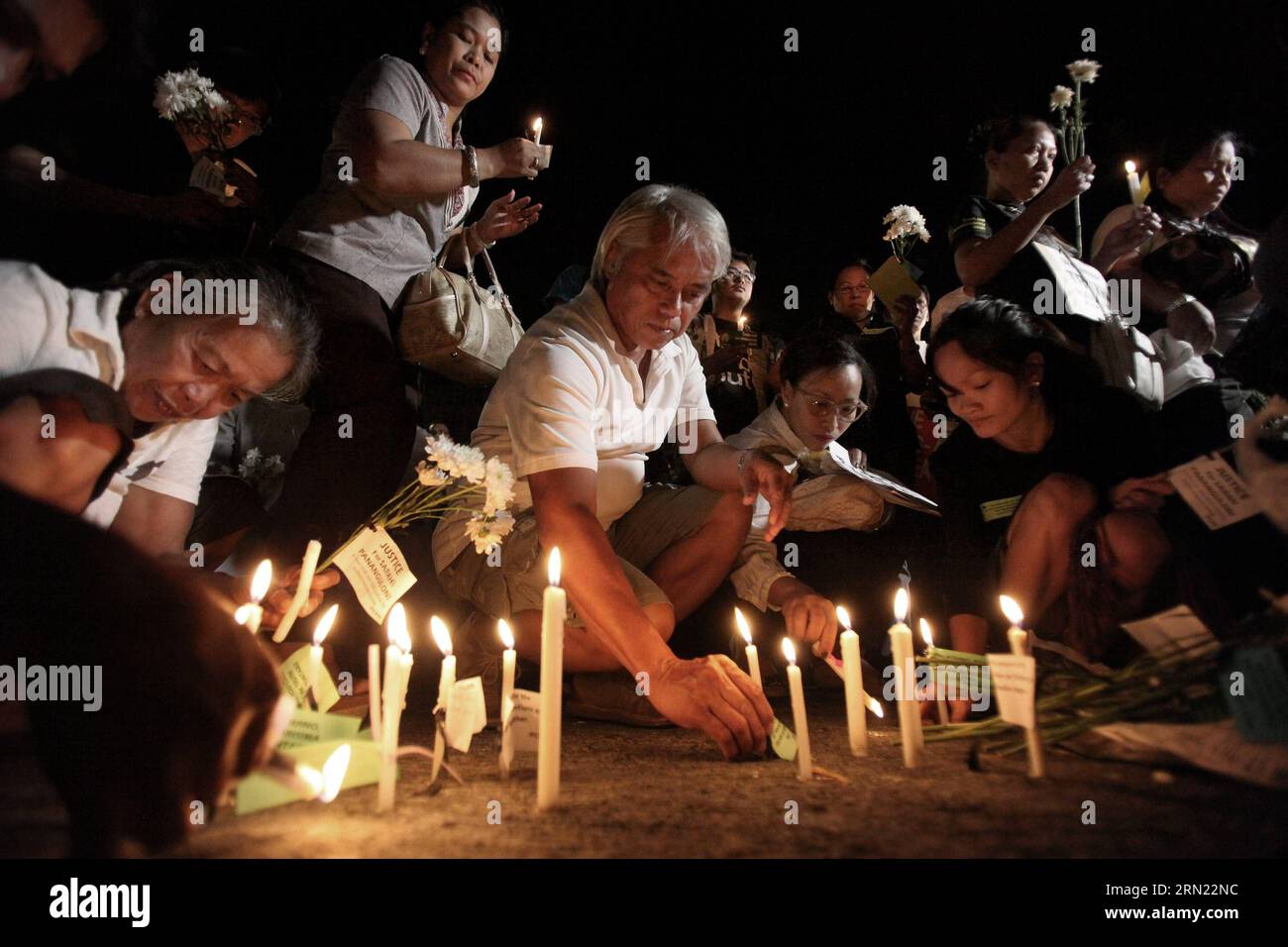 (150203) -- QUEZON CITY, Feb. 3, 2015 -- People light candles and offer flowers and prayers for the slain 49 members of the Philippine National Police Special Action Force (PNP-SAF) at the gate of the PNP Headquarters in Quezon City, the Philippines, Feb. 3, 2015. There was lack of coordination and planning between the military forces and the leadership of the PNP-SAF during the violent clash in Mamasapano, Maguindanao on Jan. 25, chief of the Armed Forces of the Philippines said on Tuesday. ) Authorized by ytfs PHILIPPINES-QUEZON CITY-CANDLE LIGHTING RouellexUmali PUBLICATIONxNOTxINxCHN   Que Stock Photo