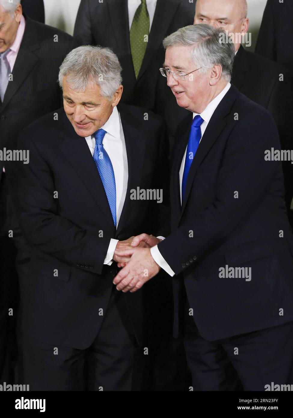 (150205) -- BRUSSELS, Feb. 5, 2015 -- British Defense Secretary Michael Fallon (R) shakes hands with his U.S. counterpart Chuck Hagel while posing for a family photo before the NATO defense ministers meeting at the Alliance headquarters in Brussels, capital of Belgium, Feb. 5, 2014. NATO Defense Ministers gathered here on Thursday to discuss the implementation of the Readiness Action Plan and the Ukraine crisis. Zhou Lei) BELGIUM-NATO-DEFENSE MINISTER-MEETING ?? PUBLICATIONxNOTxINxCHN   Brussels Feb 5 2015 British Defense Secretary Michael Fallon r Shakes Hands With His U S Part Chuck Hagel wh Stock Photo