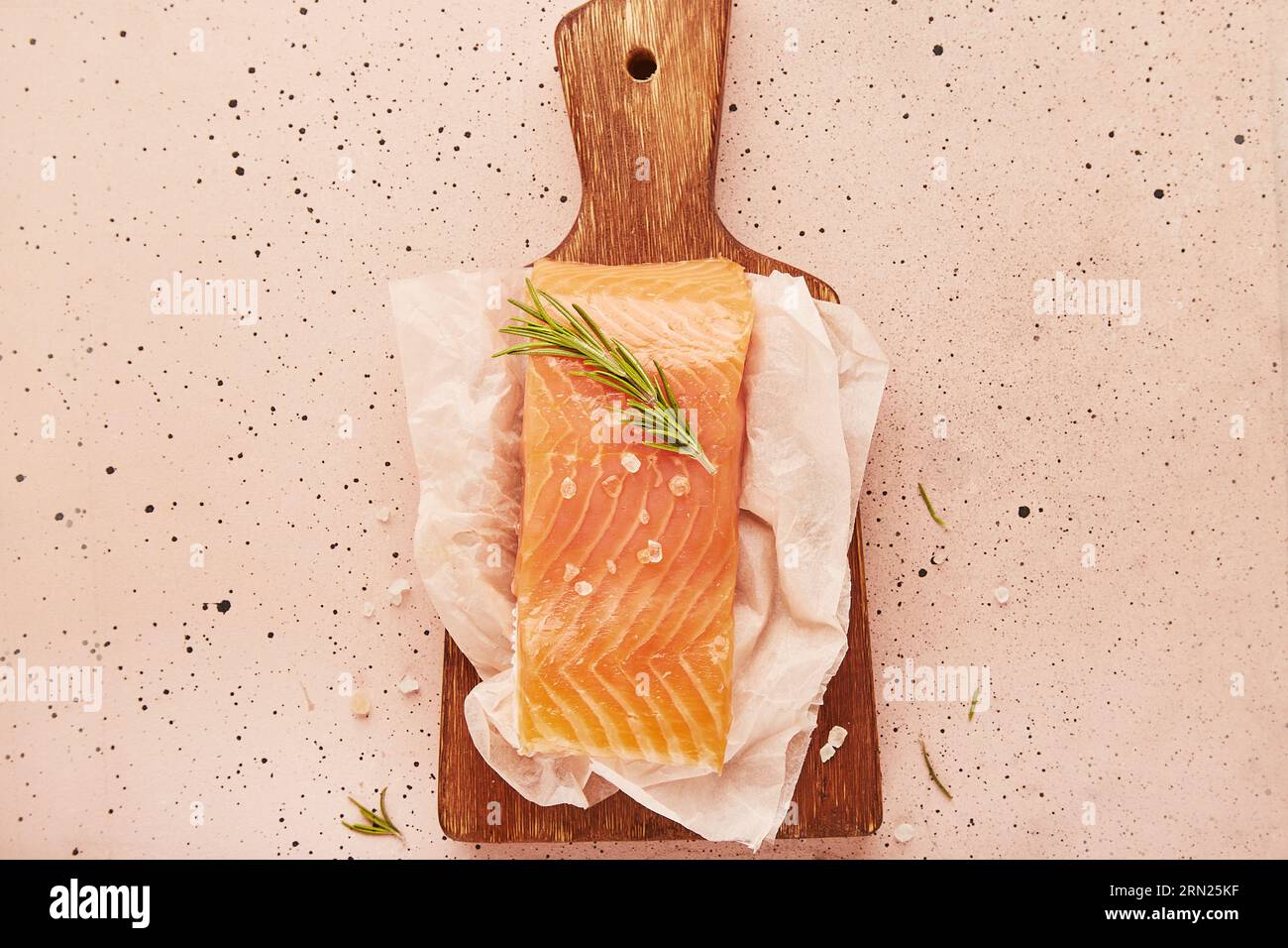Fresh fillet of smoked salmon on wooden cutting board close up. healthy food, Mediterranean diet, omega 3 Stock Photo