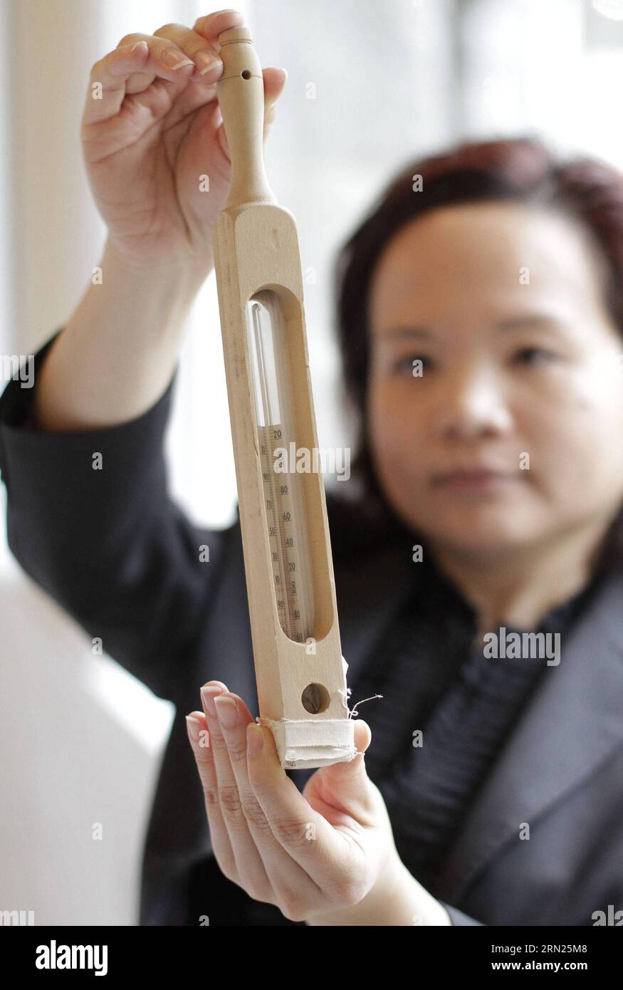 A nursing school alumni displays a thermometer used in early 19th century during the nursing school celebration event at University of British Columbia in Richmond, Canada, Feb. 10, 2015. In honour of the Canadian nursing pioneer Ethel Johns (1879-1968) named as National Historic Person of Canada, the School of Nursing in University of British Columbia held an event displaying the former nursing uniforms and historic nursing tools during the World War I to commemorate her contribution. Ethel Johns established the first university degree nursing program in Canada at the University of British Co Stock Photo