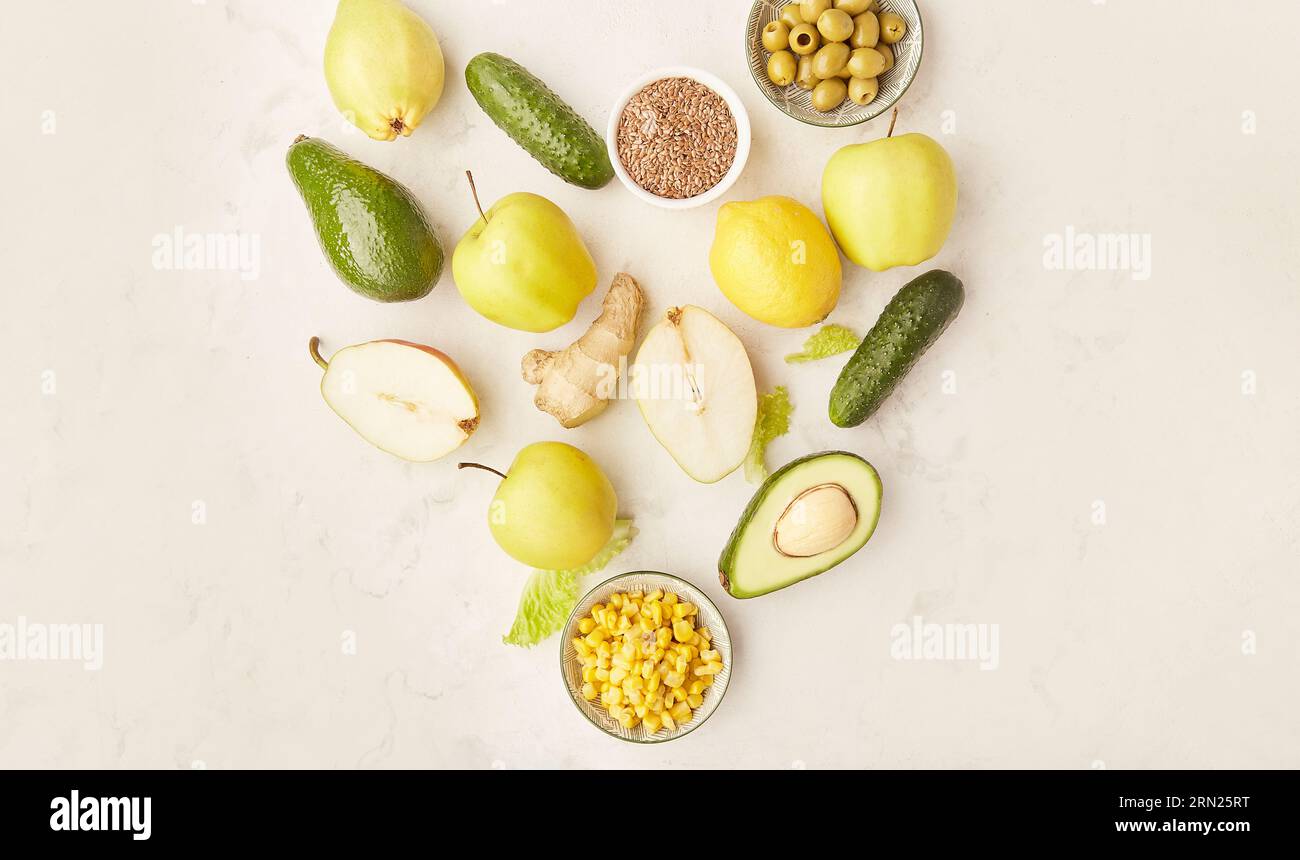 Heart shape of healthy FODMAP, Paleo, Mediterranean diet food in yellow