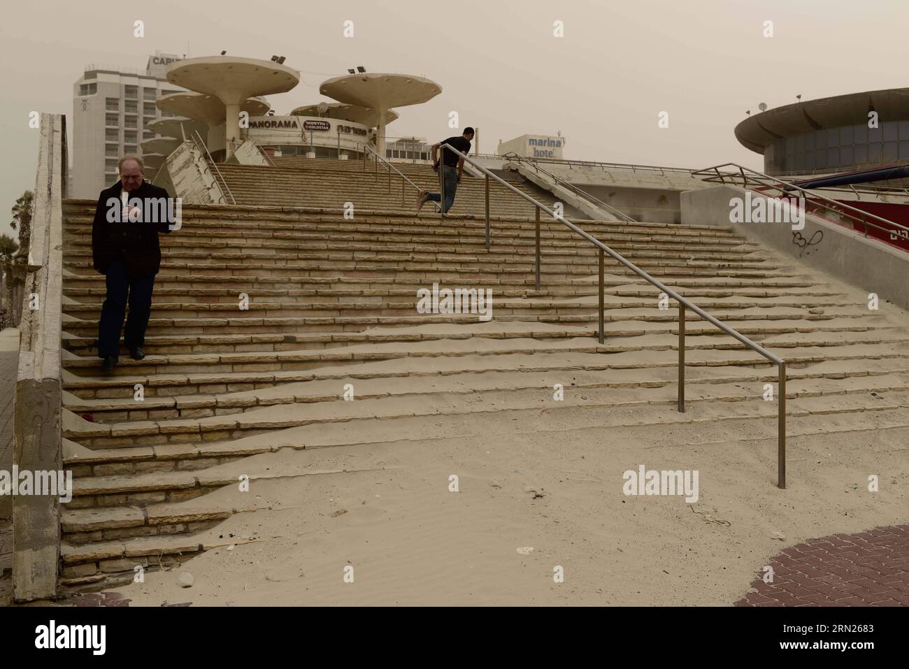 (150212) -- TEL AVIV,  Sands are blown to the seaside stairs in Tel Aviv, Israel, on Feb. 11, 2015. A sandstorm continues to blow hard in parts of the Middle East on Wednesday, where authorities have remained sea ports closed and briefly grounded flights. Israel has been hit by the developing sandstorm. The country temporarily shut down two airports and suspended all domestic flights Wednesday morning as the sandstorm hit the country, the Israel Airport Authority said in a statement. ) ISRAEL-TEL AVIV-STORM JINI/TomerxNeubeg PUBLICATIONxNOTxINxCHN   Tel Aviv Sands are blown to The Seaside Stai Stock Photo