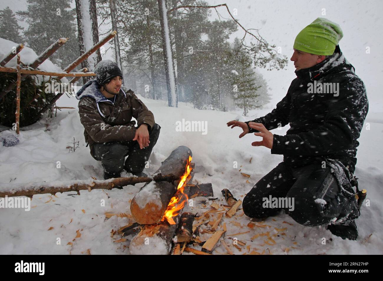 (150215) -- HELSINKI, Feb. 12, 2015 -- A Finnish coach (R) teaches a French tourist how to set fire on snow in Savukoski, northern Finland, on Feb. 12, 2015. As being trained to live in Arctic wilderness is becoming a popular recreation, many European choose to travel to Finnish Lapland to spend their winter vacations. ) FINLAND-SAVUKOSKI-ARCTIC WILDERNESS-VACATION LixJizhi PUBLICATIONxNOTxINxCHN   Helsinki Feb 12 2015 a Finnish Coach r teaches a French Tourist How to Set Fire ON Snow in  Northern Finland ON Feb 12 2015 As Being trained to Live in Arctic Wilderness IS Becoming a Popular Recrea Stock Photo