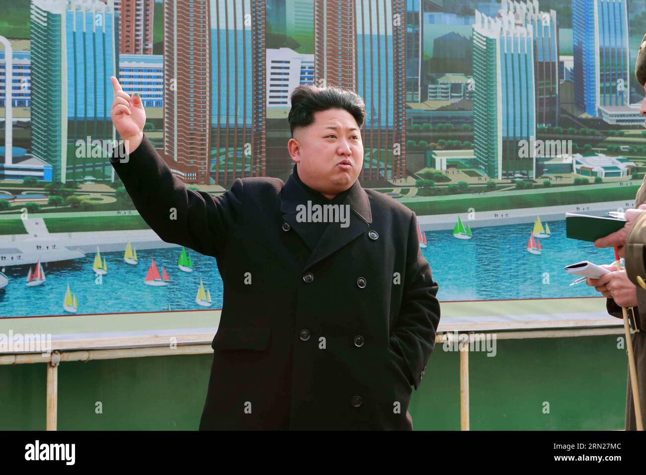 (150215) -- PYONGYANG, Feb. 15, 2015 -- Photo provided by Korean Central News Agency () on Feb. 15, 2015 shows top leader of the Democratic People s Republic of Korea (DPRK) Kim Jong Un recently inspect the construction of the Mirae Scientists Street in Pyongyang after having a bird s-eye view of it from his special plane. After being briefed on the construction before a plan showing the bird s eye-view of the street, Kim Jong Un went round flat No.1 on the second floor of block No. 77, geothermal water pumping station and various other places to learn in detail about the first phase construct Stock Photo
