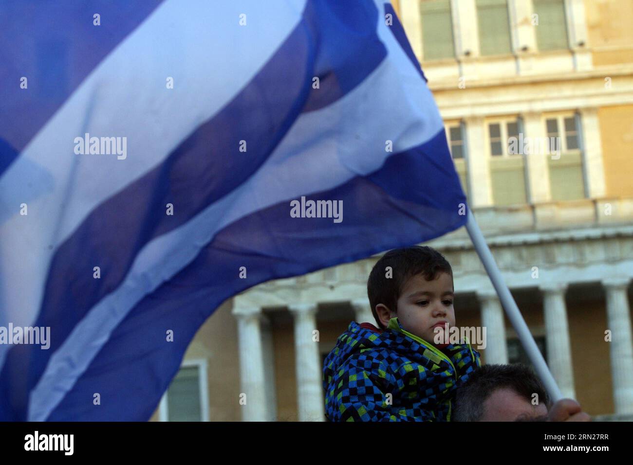 A boy attends a rally ahead of next euro group meeting on debt crisis in Athens, Greece, Feb, 15, 2015. Thousands of people gathered on Sunday in Athens and other major cities in Greece to show their support for the Greek government ahead of Monday s Eurogroup meeting on the Greek debt crisis. ) GREECE-ATHENS-POLITICS-RALLY MariosxLolos PUBLICATIONxNOTxINxCHN   a Boy Attends a Rally Ahead of Next Euro Group Meeting ON Debt Crisis in Athens Greece Feb 15 2015 thousands of Celebrities gathered ON Sunday in Athens and Other Major CITIES in Greece to Show their Support for The Greek Government Ahe Stock Photo
