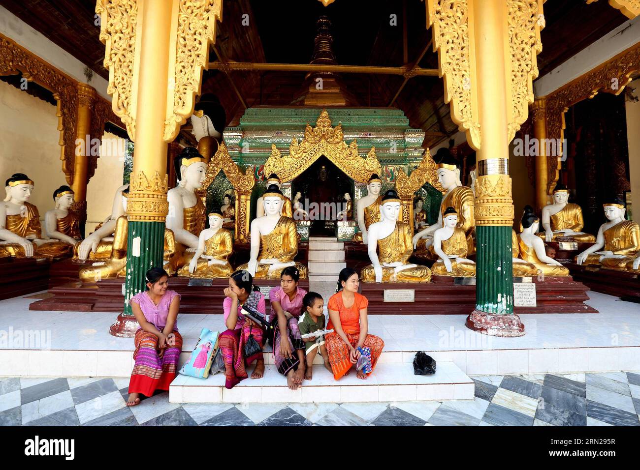 YANGON, Feb. 17, 2015 -- Visitors take a rest at the Shwedagon pagoda in Yangon, Myanmar, Feb. 17, 2015. Shwedagon Pagoda is a repository of the best of Myanmar s heritages -- architecture, sculpture and arts. It consists of hundreds of colorful temples, stupas and statues that reflect architectural styles spanning almost 2,500 years. ) MYANMAR-YANGON-SHWEDAGON PAGODA UxAung PUBLICATIONxNOTxINxCHN   Yangon Feb 17 2015 Visitors Take a Rest AT The Shwedagon Pagoda in Yangon Myanmar Feb 17 2015 Shwedagon Pagoda IS a repository of The Best of Myanmar S heritage Architecture Sculpture and Arts IT c Stock Photo