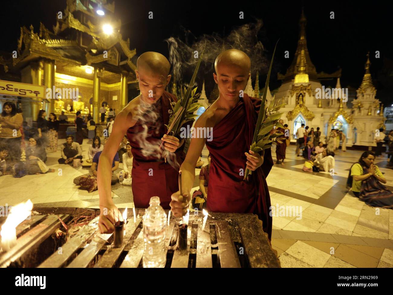 YANGON, Feb. 17, 2015 -- Buddhist novices light candles and burn incense sticks to pray at the Shwedagon pagoda in Yangon, Myanmar, Feb. 17, 2015. Shwedagon Pagoda is a repository of the best of Myanmar s heritages -- architecture, sculpture and arts. It consists of hundreds of colorful temples, stupas and statues that reflect architectural styles spanning almost 2,500 years. ) MYANMAR-YANGON-SHWEDAGON PAGODA UxAung PUBLICATIONxNOTxINxCHN   Yangon Feb 17 2015 Buddhist novices Light Candles and Burn incense Sticks to Pray AT The Shwedagon Pagoda in Yangon Myanmar Feb 17 2015 Shwedagon Pagoda IS Stock Photo