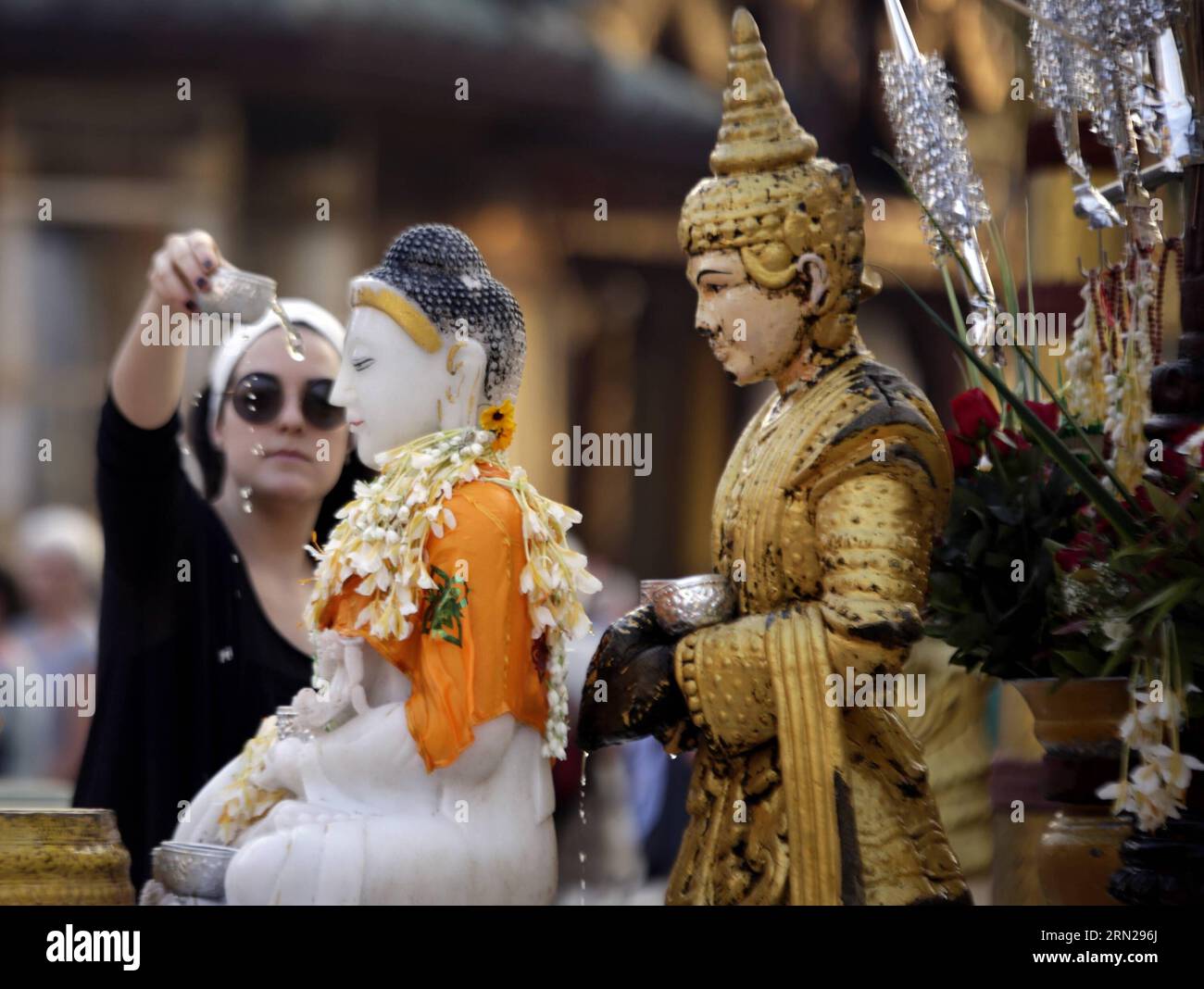 YANGON, Feb. 17, 2015 -- A visitor pours water over a Buddha statue at the Shwedagon pagoda in Yangon, Myanmar, Feb. 17, 2015. Shwedagon Pagoda is a repository of the best of Myanmar s heritages -- architecture, sculpture and arts. It consists of hundreds of colorful temples, stupas and statues that reflect architectural styles spanning almost 2,500 years. ) MYANMAR-YANGON-SHWEDAGON PAGODA UxAung PUBLICATIONxNOTxINxCHN   Yangon Feb 17 2015 a Visitor pour Water Over a Buddha Statue AT The Shwedagon Pagoda in Yangon Myanmar Feb 17 2015 Shwedagon Pagoda IS a repository of The Best of Myanmar S he Stock Photo