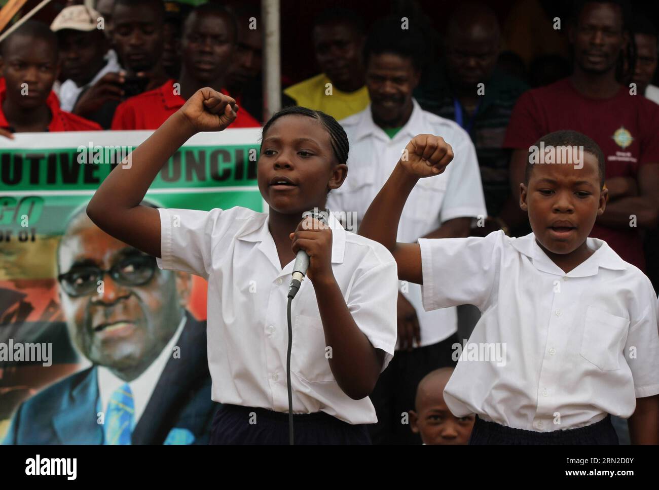 (150228) -- VICTORIA FALLS (ZIMBABWE), Feb. 28, 2015 () -- Two students speak to show support at a public celebration held to mark the 91st birthday of Zimbabwean President Robert Mugabe in Victoria Falls, Zimbabwe, Feb. 28, 2015. Mugabe, who turns 91 this month, is the oldest leader in the world and one of the longest-serving African statesmen. Having ruled Zimbabwe for 35 years since independence, Mugabe was endorsed by the ruling ZANU-PF party as the sole candidate to contest at the age of 94 in the next presidential election in 2018. () ZIMBABWE-VICTORIA FALLS-MUGABE-BIRTHDAY Xinhua PUBLIC Stock Photo