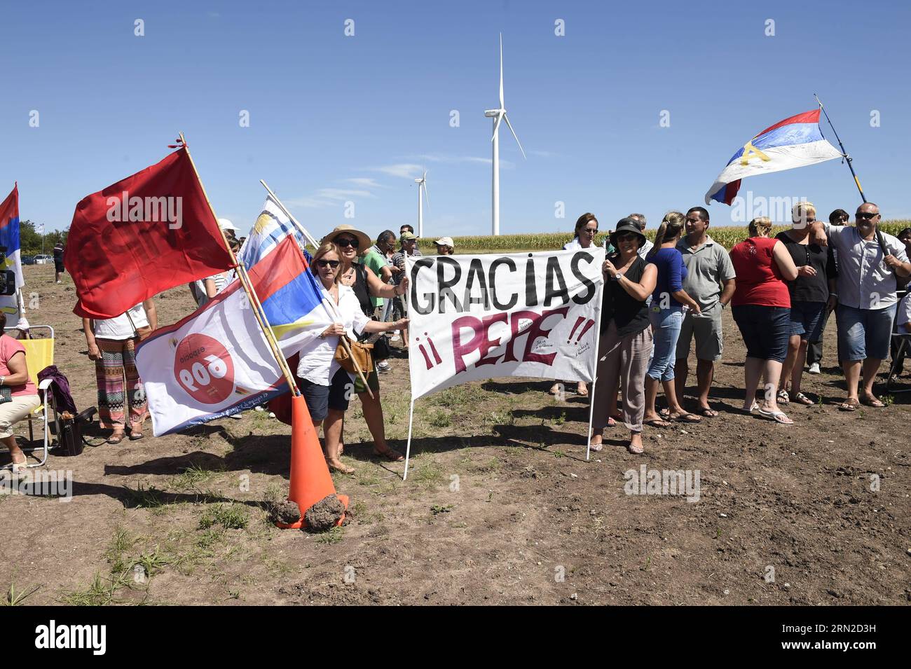 Supporters holding banners and flags attend the opening ceremony of the Wind Park, in Colonia department, 165 km from Montevideo, capital of Uruguay, on Feb. 28, 2015. The Wind Park is a joint venture between the National Administrations of Power Plants and Electrical Transmissions of Uruguay and the Brazilian Electrobras, with an investment of 100 million U.S. dollars to supply the electrical grids of both countries. Nicolas Celaya) URUGUAY-COLONIA-BRAZIL-POLITICS-WIND PARK e NICOLASxCELAYA PUBLICATIONxNOTxINxCHN   Supporters Holding Banners and Flags attend The Opening Ceremony of The Wind P Stock Photo