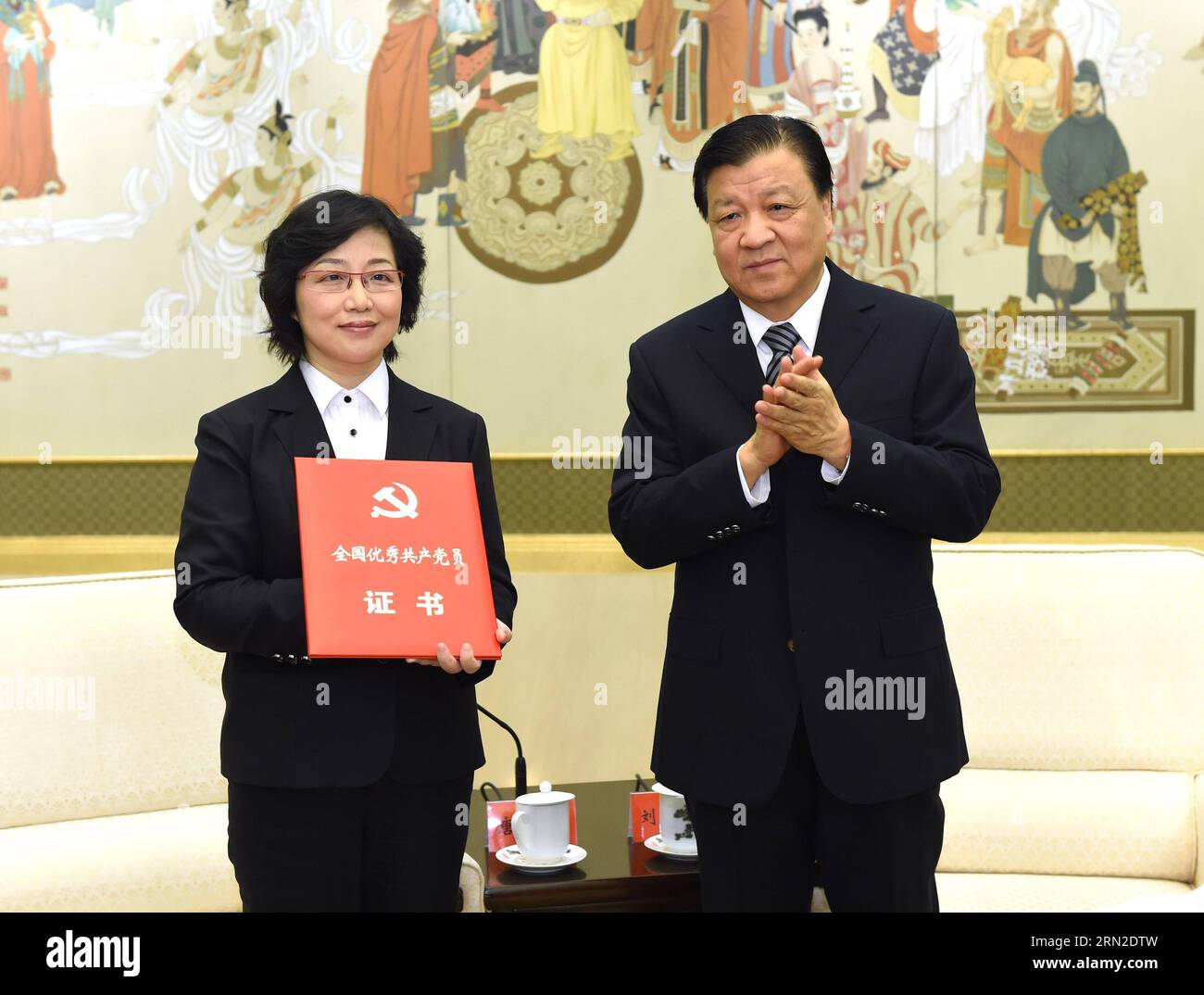 (150302) -- BEIJING, March 2, 2015 -- Liu Yunshan (R), a member of the Standing Committee of the Political Bureau of the Communist Party of China (CPC) Central Committee, confers an honorary credential for Zou Bihua, a late judge, to one of Zou s relatives, at the Great Hall of the People in Beijing, capital of China, March 2, 2015. Zou Bihua, former deputy head of Shanghai Higher People s Court, suffered a heart attack in December and died at the age of 47 after devoting himself to a judicial career for 26 years. ) (zkr) CHINA-BEIJING-LIU YUNSHAN-MEETING(CN) RaoxAimin PUBLICATIONxNOTxINxCHN Stock Photo