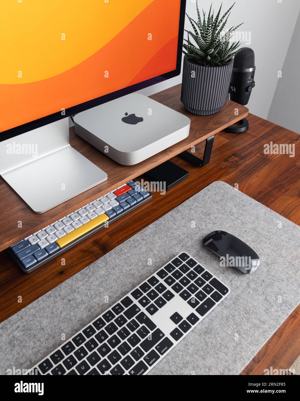 LONDON - AUGUST 24, 2023: Apple Studio Display and Mac Mini computer in ...