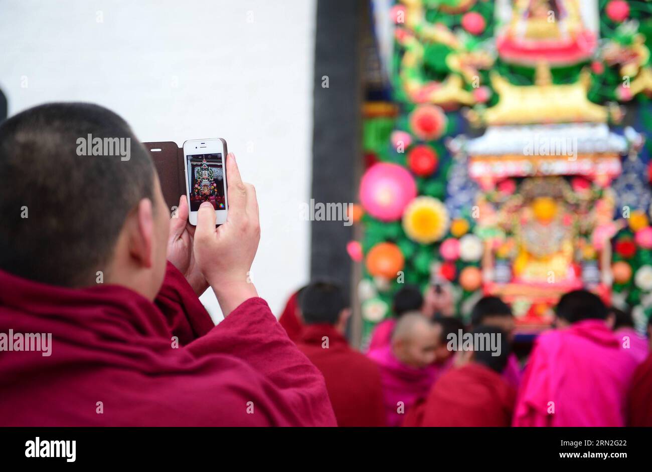 (150305) -- XIAHE, March 5, 2015 -- A monk take pictures of ghee flower artworks at Labrang Monastery in Xiahe, northwest China s Gansu Province, March 5, 2015. Ghee flower exhibitions are held in Taer Monastery in Qinghai Province and Labrang Monastery in Gansu Province, both presitigious Tibetan Buddhist monasteries, to celebrate the Lantern Festival on March 5. ) (zkr) CHINA-QINGHAI-GANSU-GHEE FLOWER-EXHIBITIONS (CN) FanxPeikun PUBLICATIONxNOTxINxCHN   Xiahe March 5 2015 a Monk Take Pictures of Ghee Flower Artworks AT Labrang monastery in Xiahe Northwest China S Gansu Province March 5 2015 Stock Photo