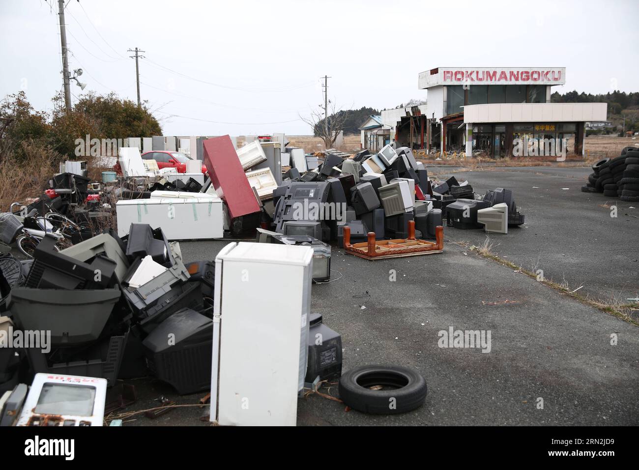 (150310) -- FUKUSHIMA, March 10, 2015 -- Abandoned houses and wastes are seen in the Futaba District, located well within the 20-kilometer exclusion radius around the leaking facilities of Fukushima Daiichi nuclear power plant, in Fukushima Prefecture, Japan, March 7, 2015. The scenes from the towns and villages still abandoned four years after an earthquake triggered tsunami breached the defenses of the Fukushima Daiichi nuclear power plant, would make for the perfect backdrop for a post- apocalyptic Hollywood zombie movie, but the trouble would be that the levels of radiation in the area wou Stock Photo