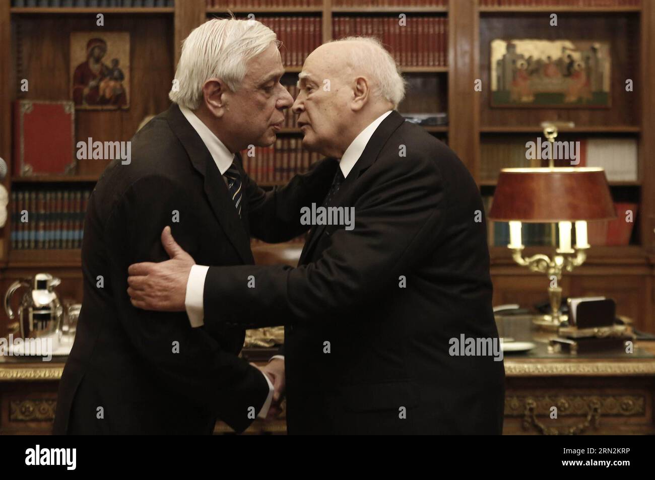 (150313) -- ATHENS, March 13, 2015 -- Outgoing Greek President Karolos Papoulias (R) hugs the newly elected President Prokopis Pavlopoulos during a handover ceremony at the Presidential Palace in Athens, Greece, on March 13, 2015. The new president of the Hellenic Republic, Prokopis Pavlopoulos, was sworn in on Friday. ) GREECE-ATHENS-POLITICS-NEW PRESIDENT YannisxKolesidis/Pool PUBLICATIONxNOTxINxCHN   Athens March 13 2015 Outgoing Greek President Karolos Papoulias r Hugs The newly Elected President Prokopis Pavlopoulos during a Handover Ceremony AT The Presidential Palace in Athens Greece ON Stock Photo