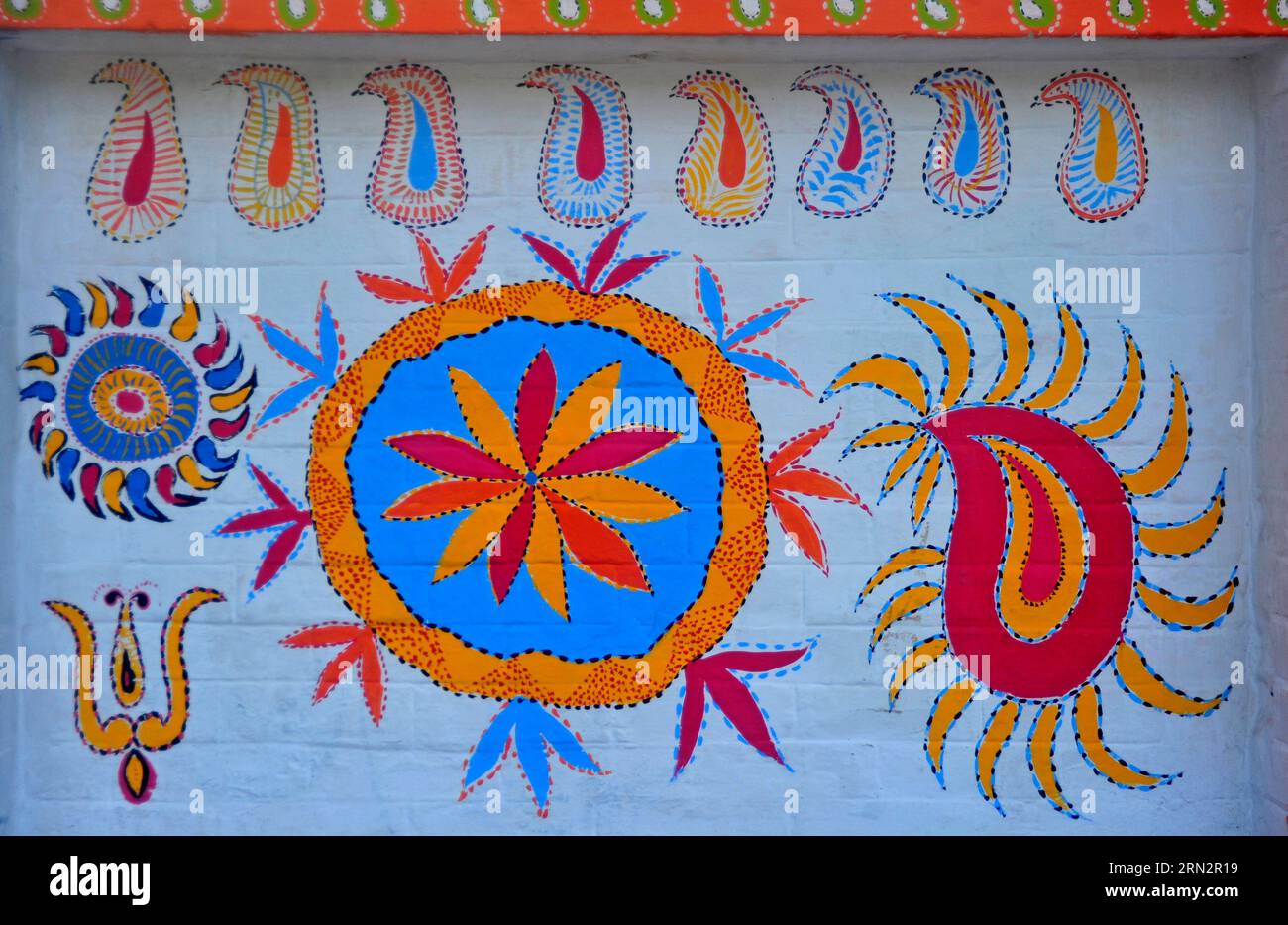 Artists paint folk motifs on the wall of fine arts faculty at Dhaka University, Bangladesh, 13 April, 2023. As part of the campus decoration for Pahel Stock Photo