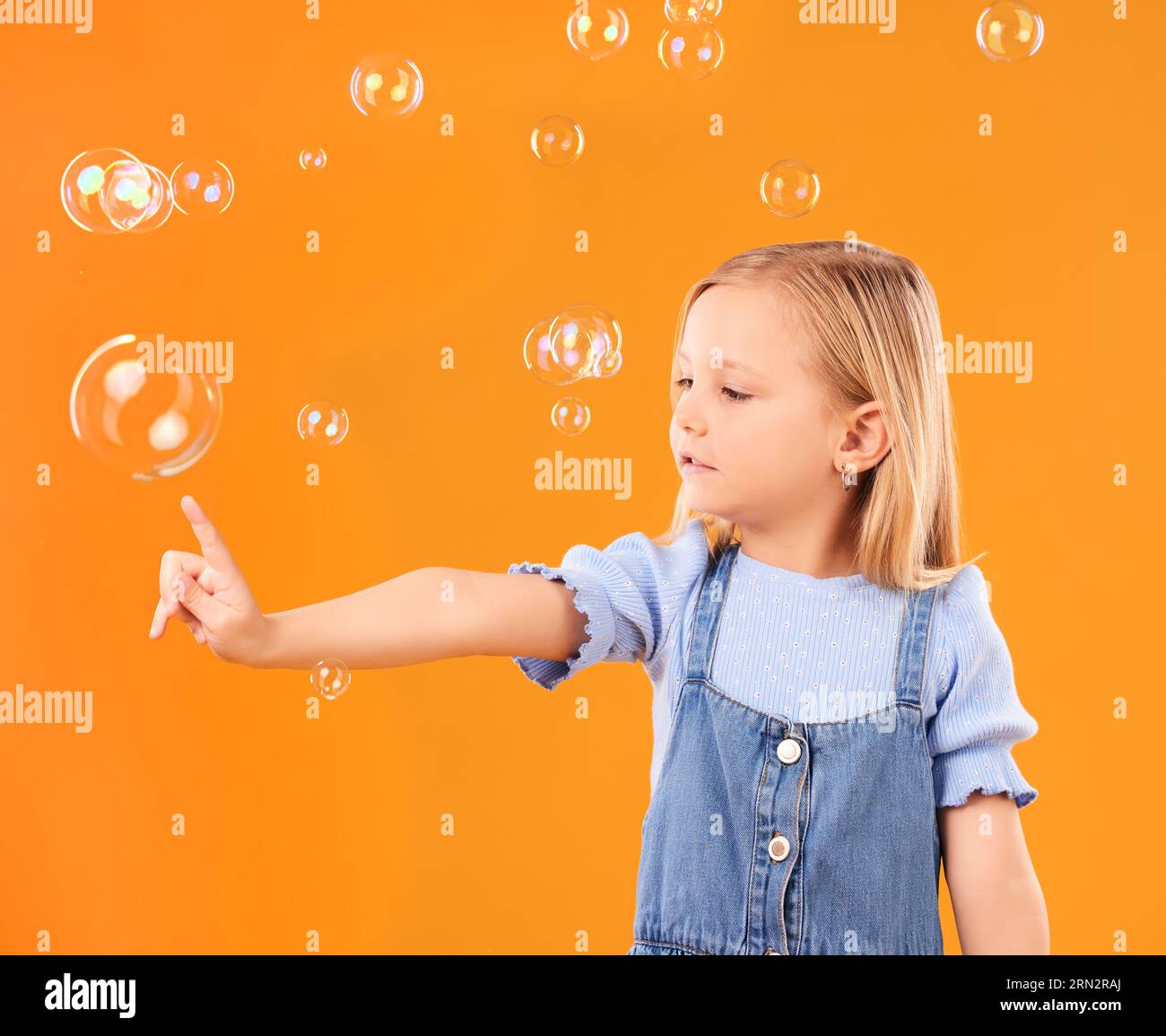 Young girl child, pop bubbles and game, playing and fun with youth