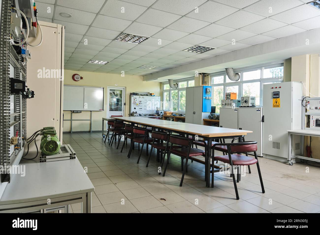 empty classroom workshop. empty class in a university with a group round table. class. with equipment. on the walls Stock Photo
