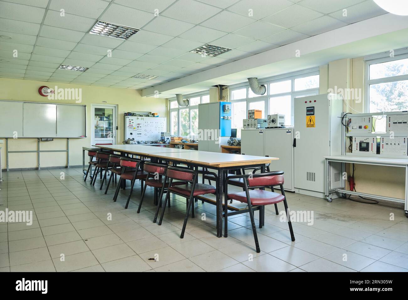empty classroom workshop. empty class in a university with a group round table. class. with equipment. on the walls Stock Photo
