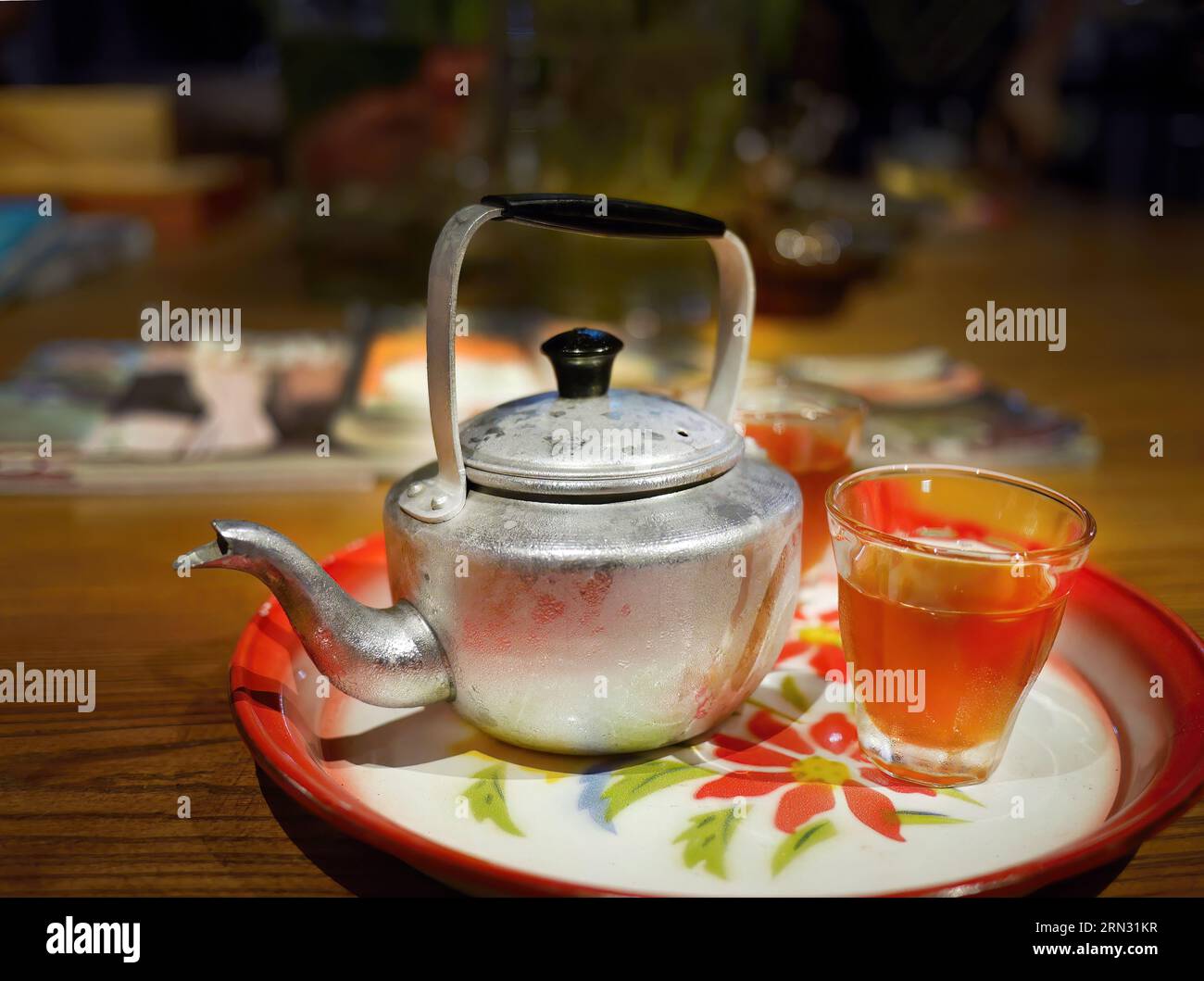 Cold Ice tea in a vintage Tin metal teapot or kettle and a transparent