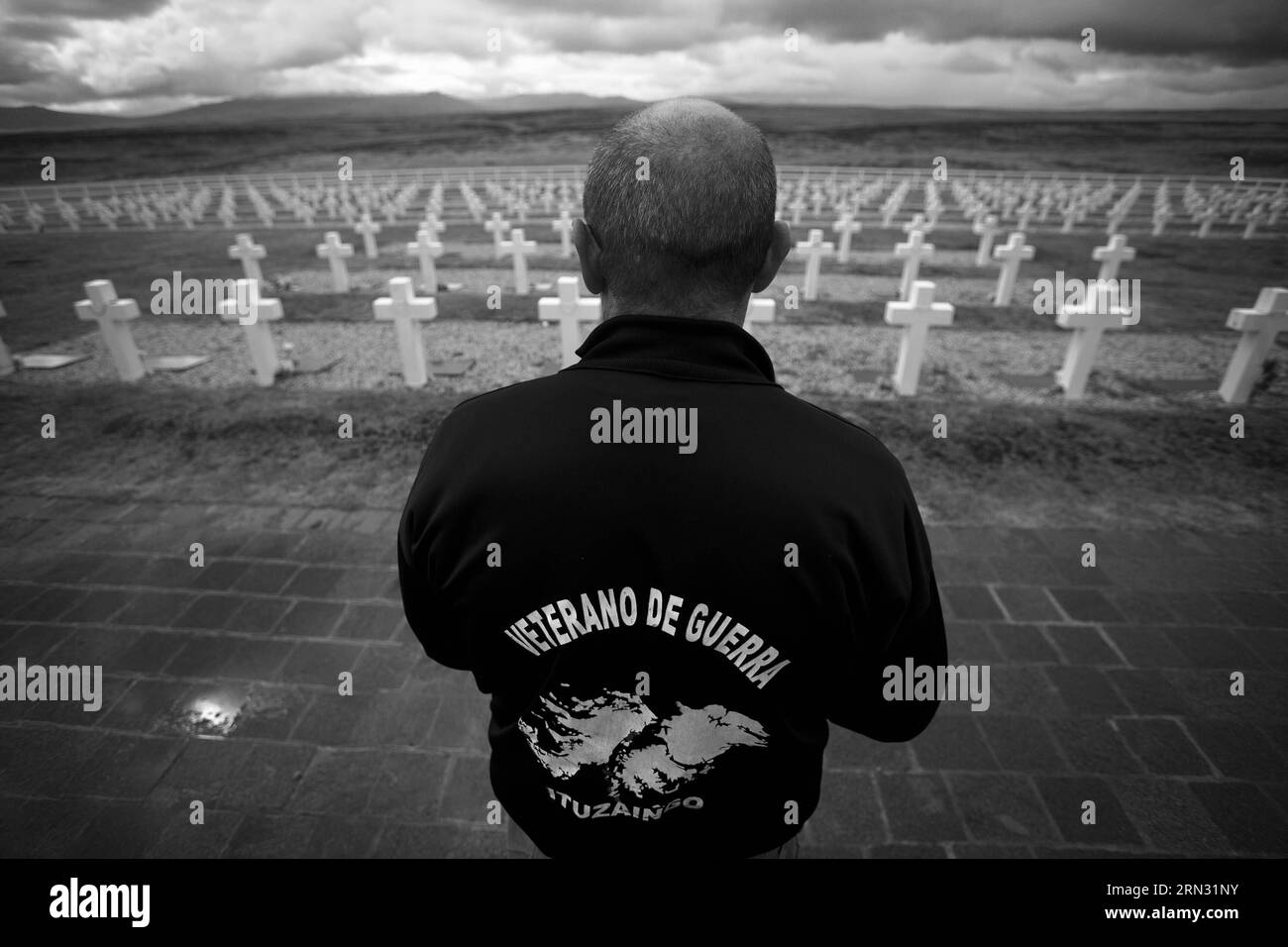 (150402) -- PORT DARWIN, Apr. 2, 2015 -- Image taken on March 13, 2013, shows Eduardo Miravetto, a veteran of the war in 1982, looking at the tombs of the Argentinean fallen soldiers during his visit at the Darwin Cementery, near Port Darwin, Falkland Islands. Argentine Foreign Minister Hector Timerman on March 30, 2015 wrote to international organizations to denounce Britain for boosting military presence in the Malvinas Islands, known as the Falklands in the European country. Britain and Argentina went to war over the islands in 1982, after Argentina ventured to reclaim the territory by send Stock Photo