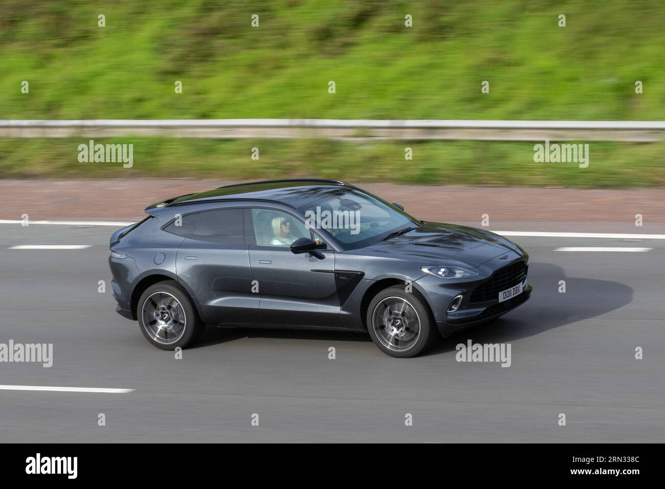2020 Aston Martin Dbx V8 Auto Bi-Turbo V8 550 Touchtronic Auto Start/Stop Grey Car SUV Petrol 3982 cc travelling at speed on the M6 motorway in Greater Manchester, UK Stock Photo